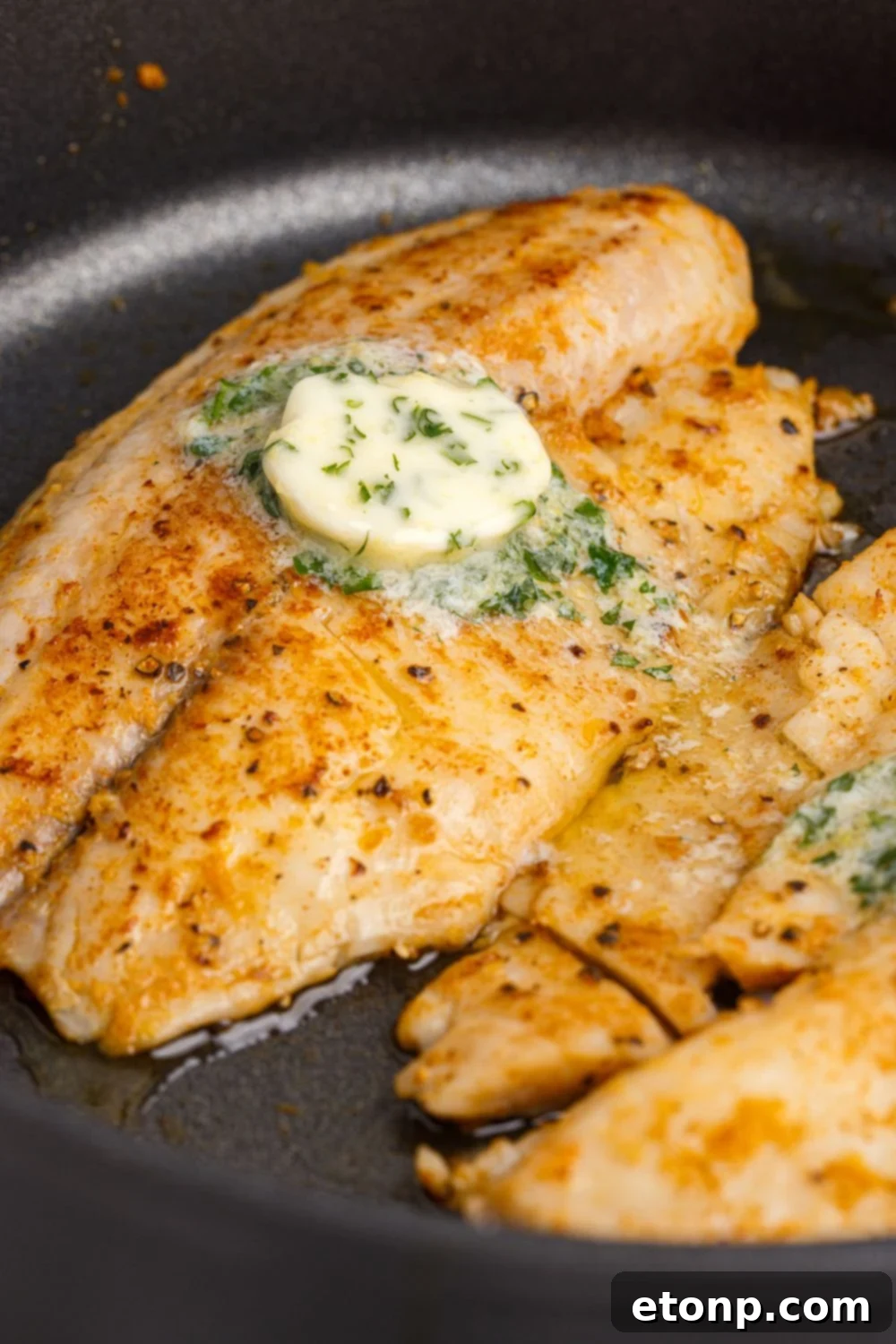 Pan Fried Tilapia in a skillet in a pan