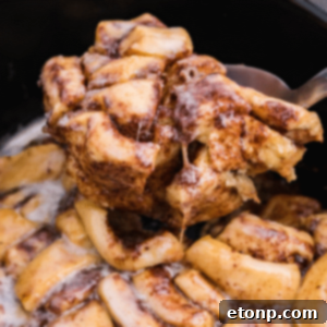 Crock Pot Cinnamon Roll Casserole in a crock pot, ready to be served