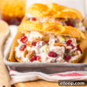 Cranberry Pecan Chicken Salad in a roll on a metal serving platter