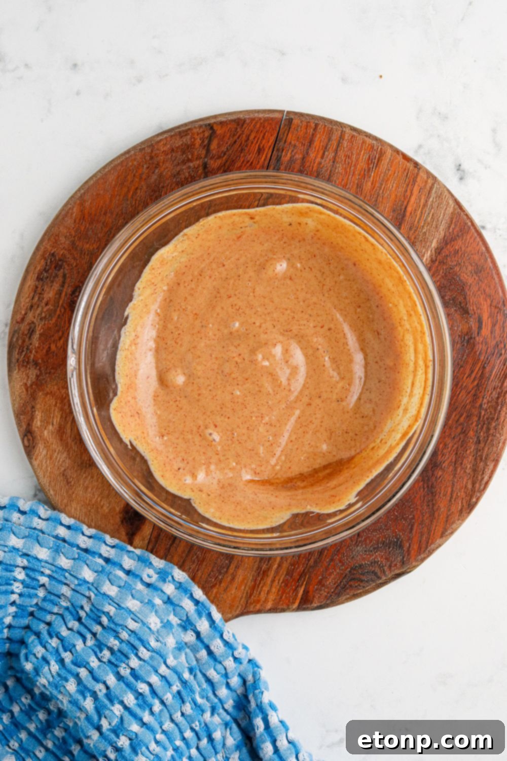 Cowboy Burger sauce mixed in a bowl on wooden cutting board 