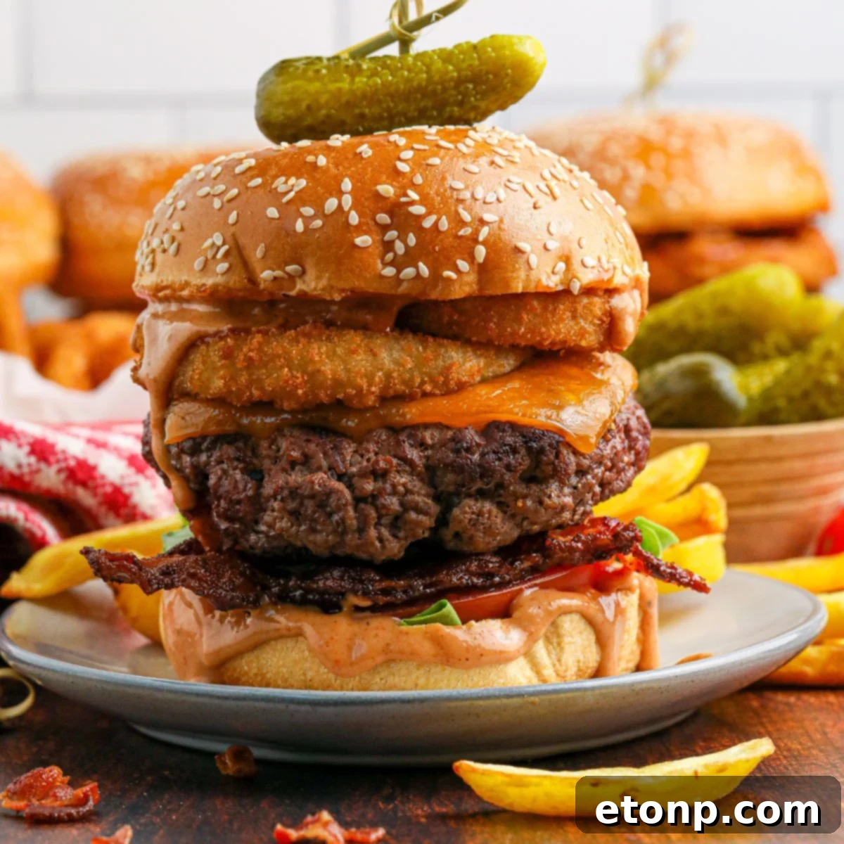 Cowboy Burger on plate that is fully loaded with toppings 