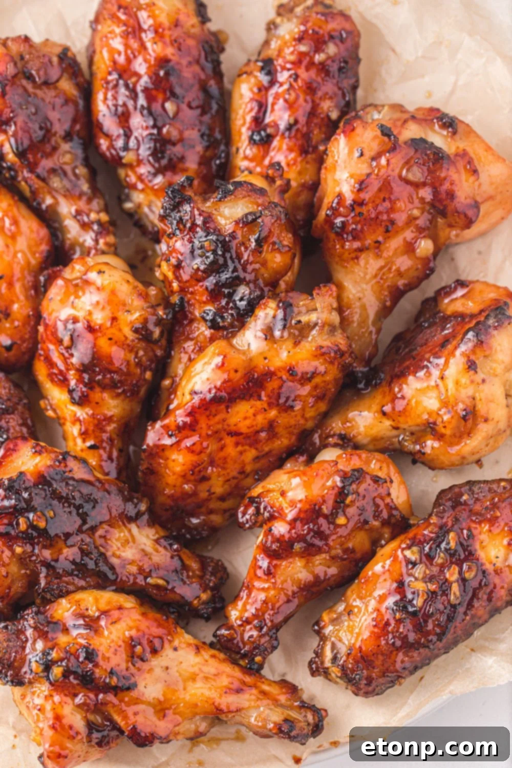 The Best Crispy Honey Garlic Air Fryer Chicken Wings 12 A tray filled with freshly air-fried honey garlic chicken wings, showcasing their sticky glaze and golden-brown skin, spread out evenly.