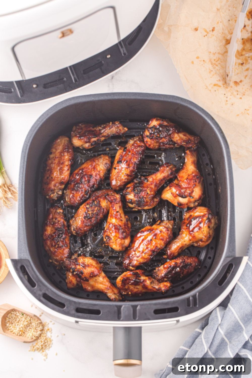 The Best Crispy Honey Garlic Air Fryer Chicken Wings 13 Air fryer basket filled with glazed chicken wings after their final crisping, looking perfectly sticky and delicious.