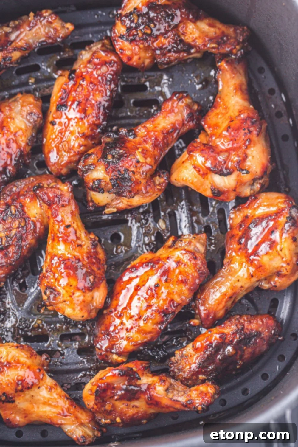 The Best Crispy Honey Garlic Air Fryer Chicken Wings 14 Air Fryer Honey Garlic Chicken Wings in the air fryer basket, showing them golden and ready for glazing.