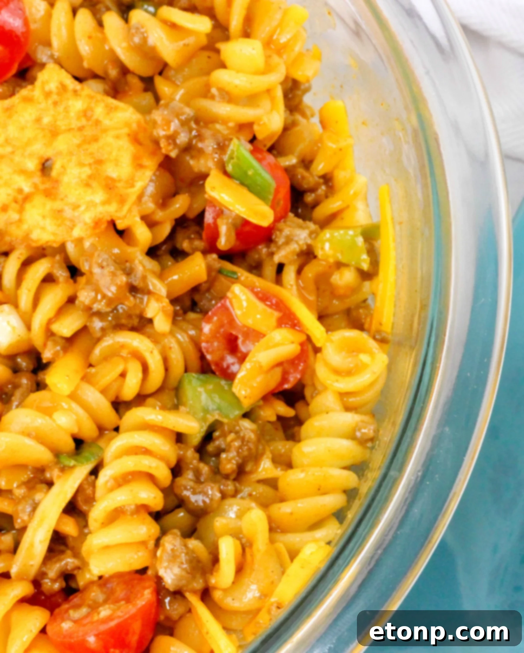 A final close-up of the Doritos Taco Pasta Salad, beautifully presented with garnishes, emphasizing its fresh ingredients and inviting appeal.