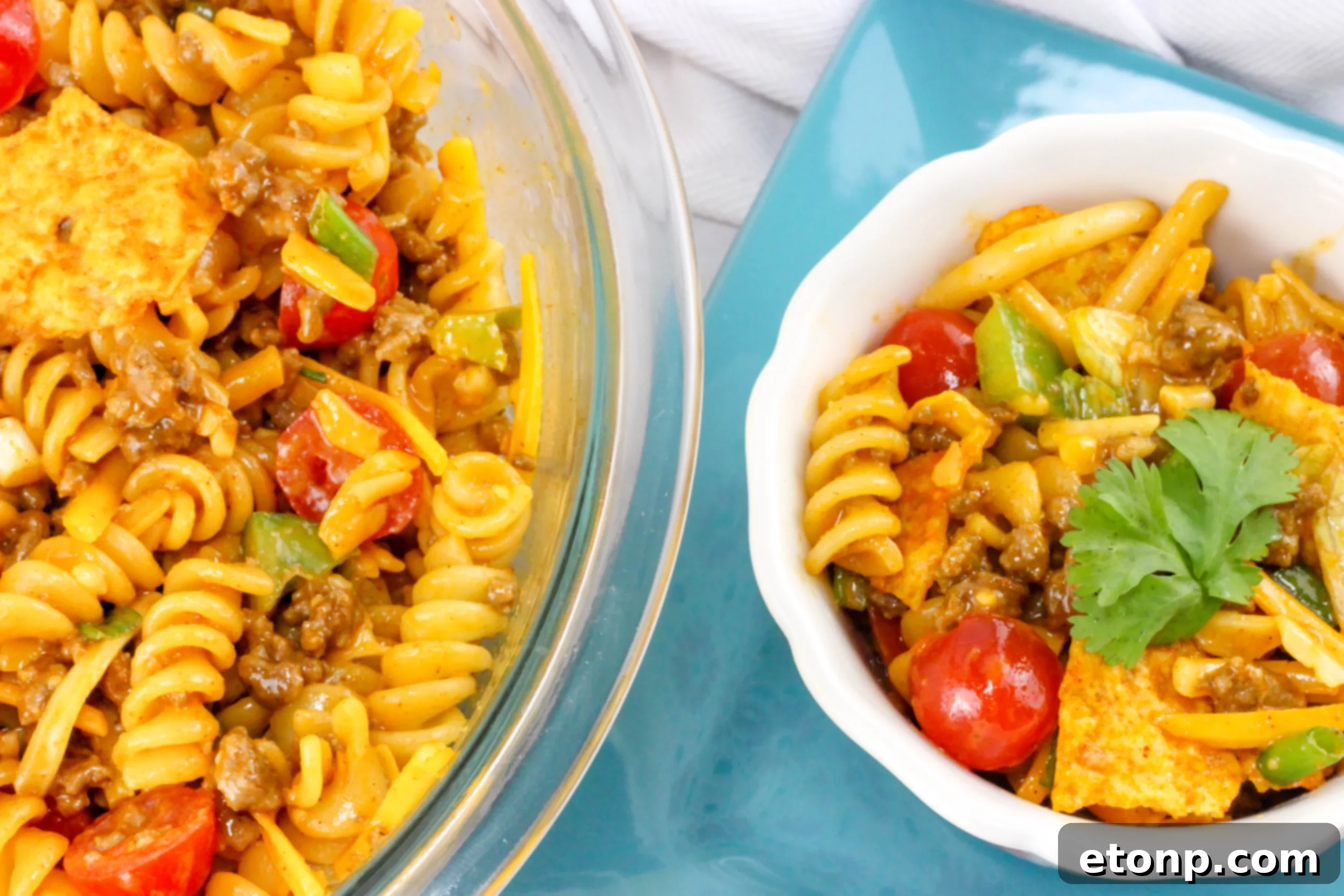 A close-up of a single serving of Doritos Taco Pasta Salad, highlighting the mix of ingredients and the distinct pieces of crunchy Doritos chips.