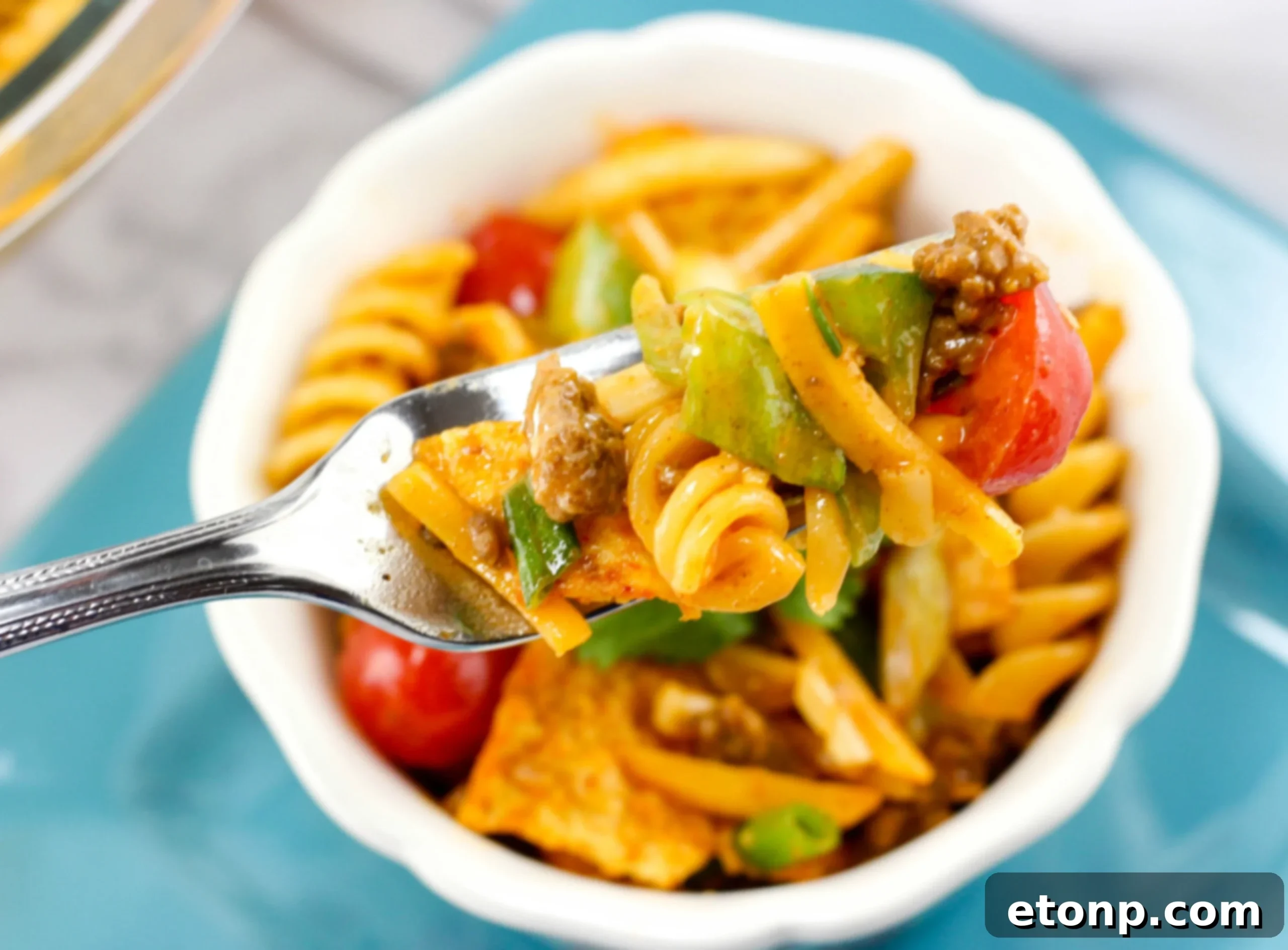 Another perspective of the delicious Doritos Taco Pasta Salad, showcasing the finely diced vegetables and a glimpse of the creamy dressing coating the pasta.