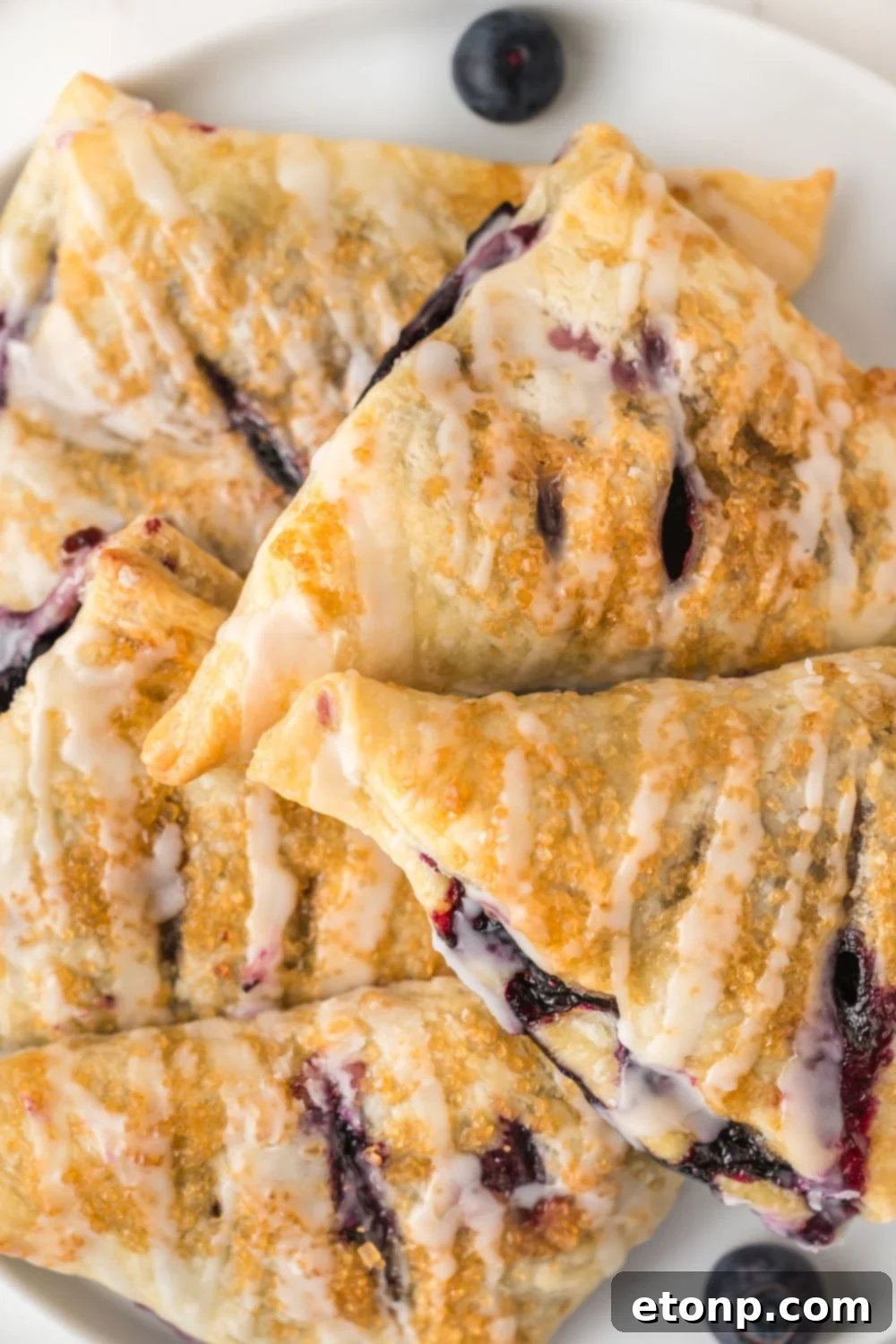 Blueberry Turnovers stacked on a plate 