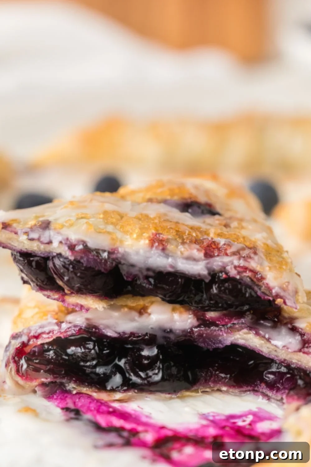 Blueberry Turnovers sliced and stacked on top of one another 