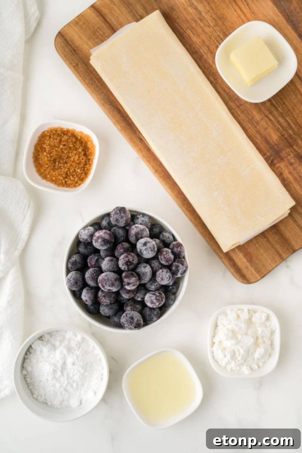 ingredients for Blueberry Turnovers in single serve containers sitting on table to show all the items 