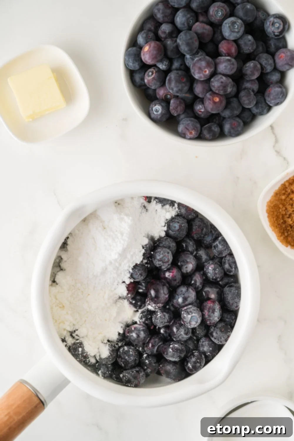blueberry and sugar mixture in a bowl for making a blueberry sauce