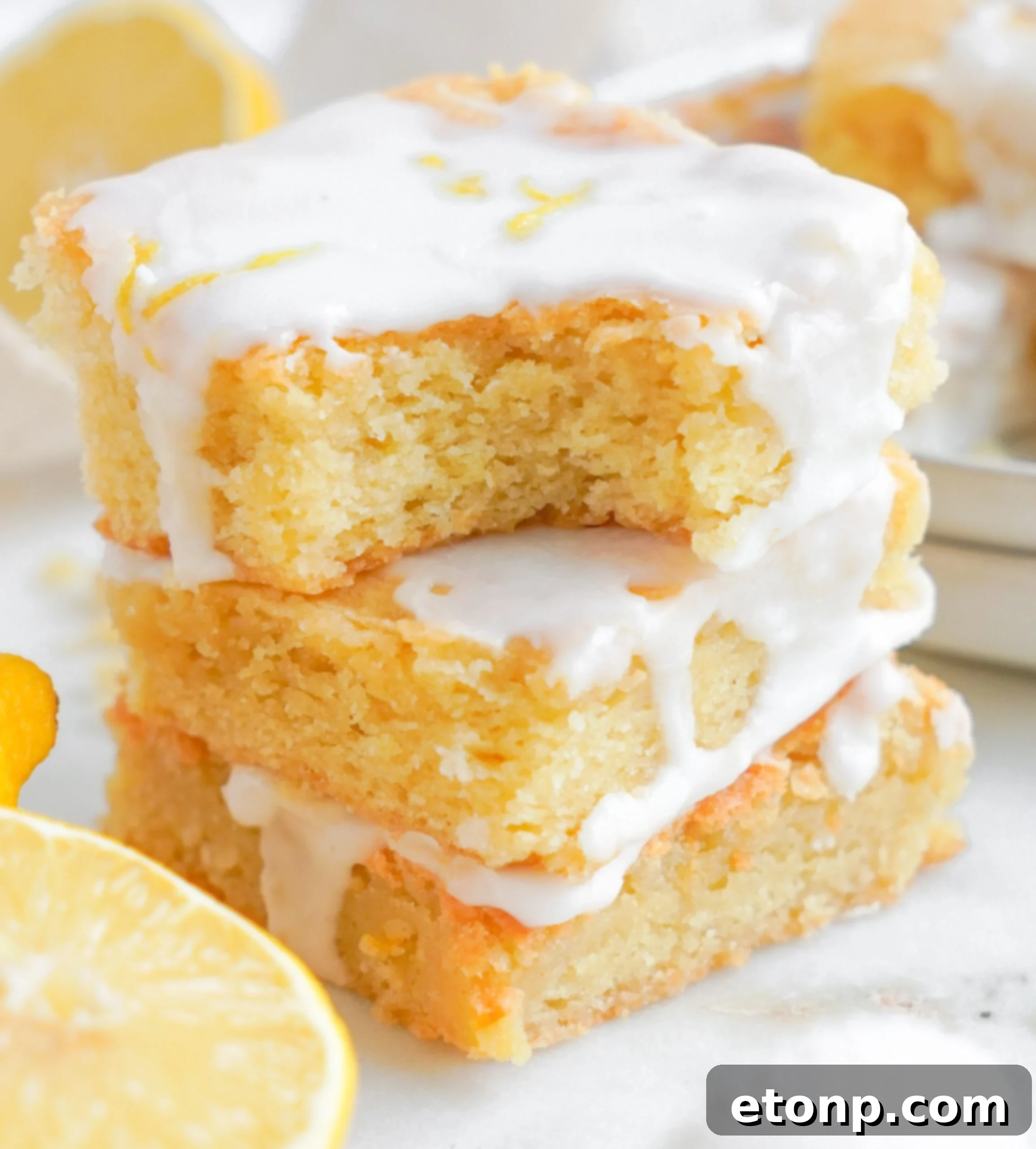 Lemon Sugar Cookie Bars up close with a bite missing 