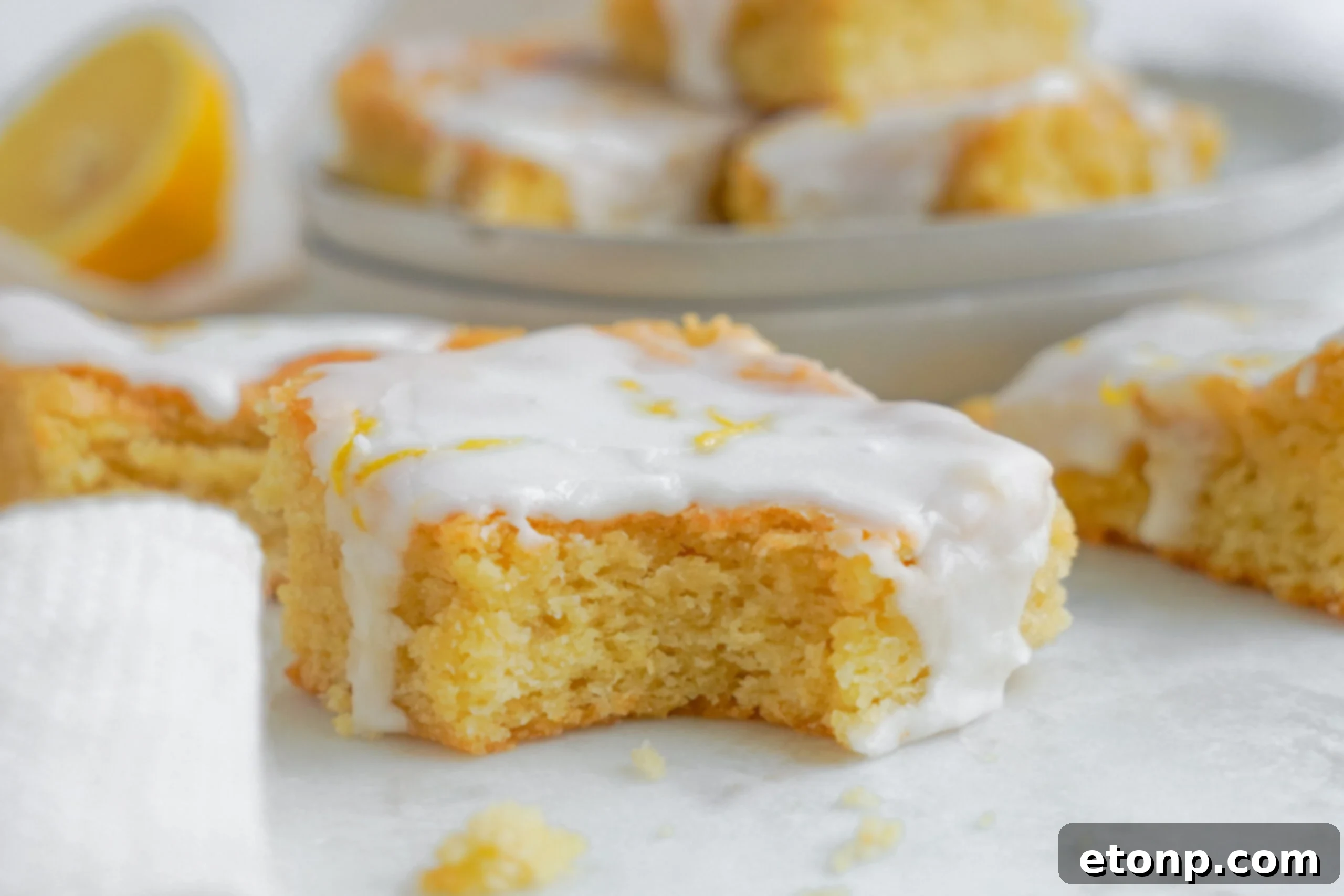 lemon bar up close with a bite missing 