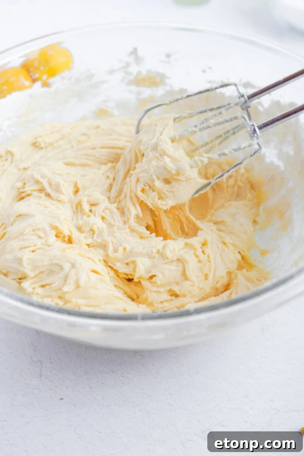 whipped batter for Lemon Sugar Cookie Bars in a glass bowl 