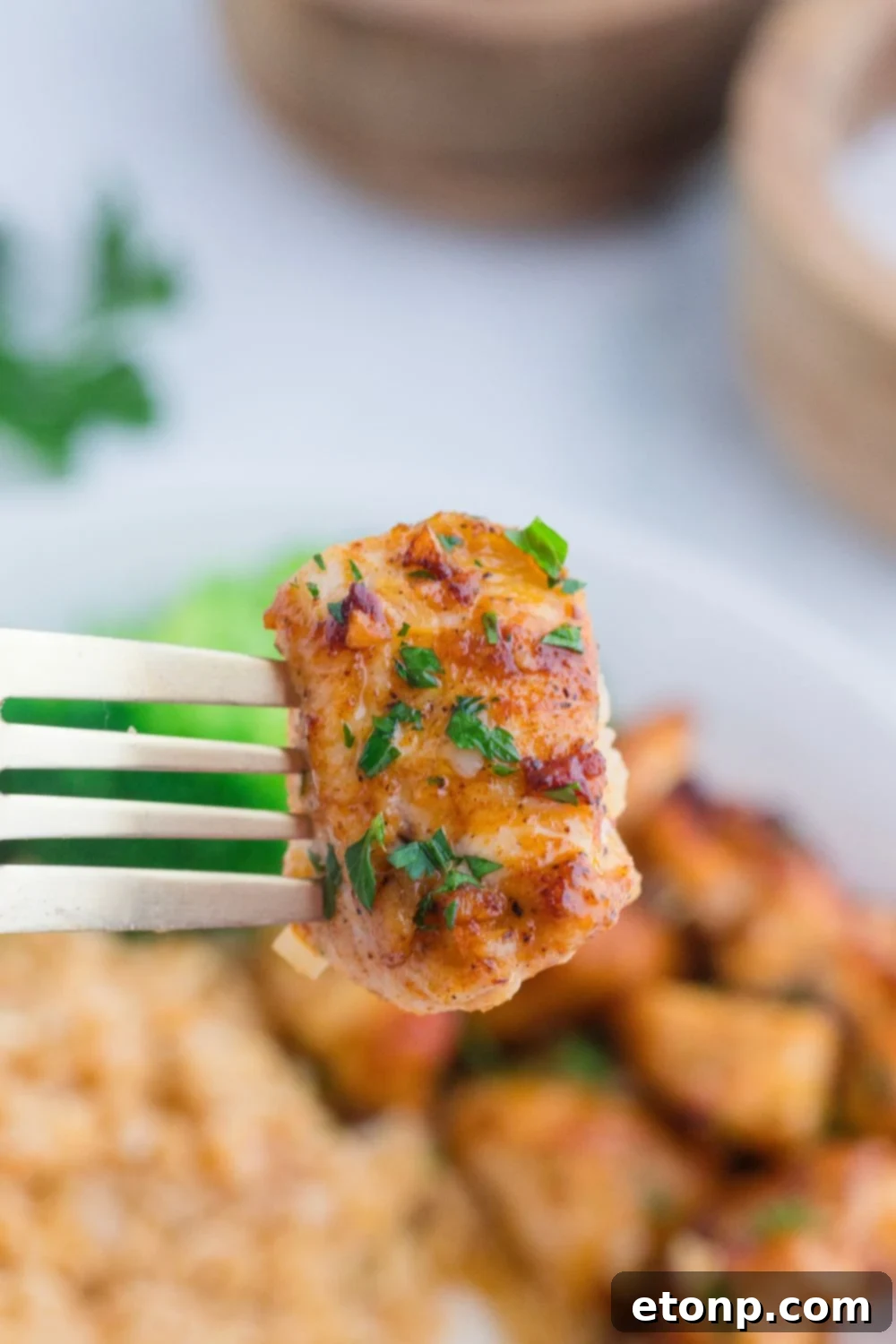 Buttery Garlic Chicken Bites 11 Garlic Butter Chicken Bite on fork above plate