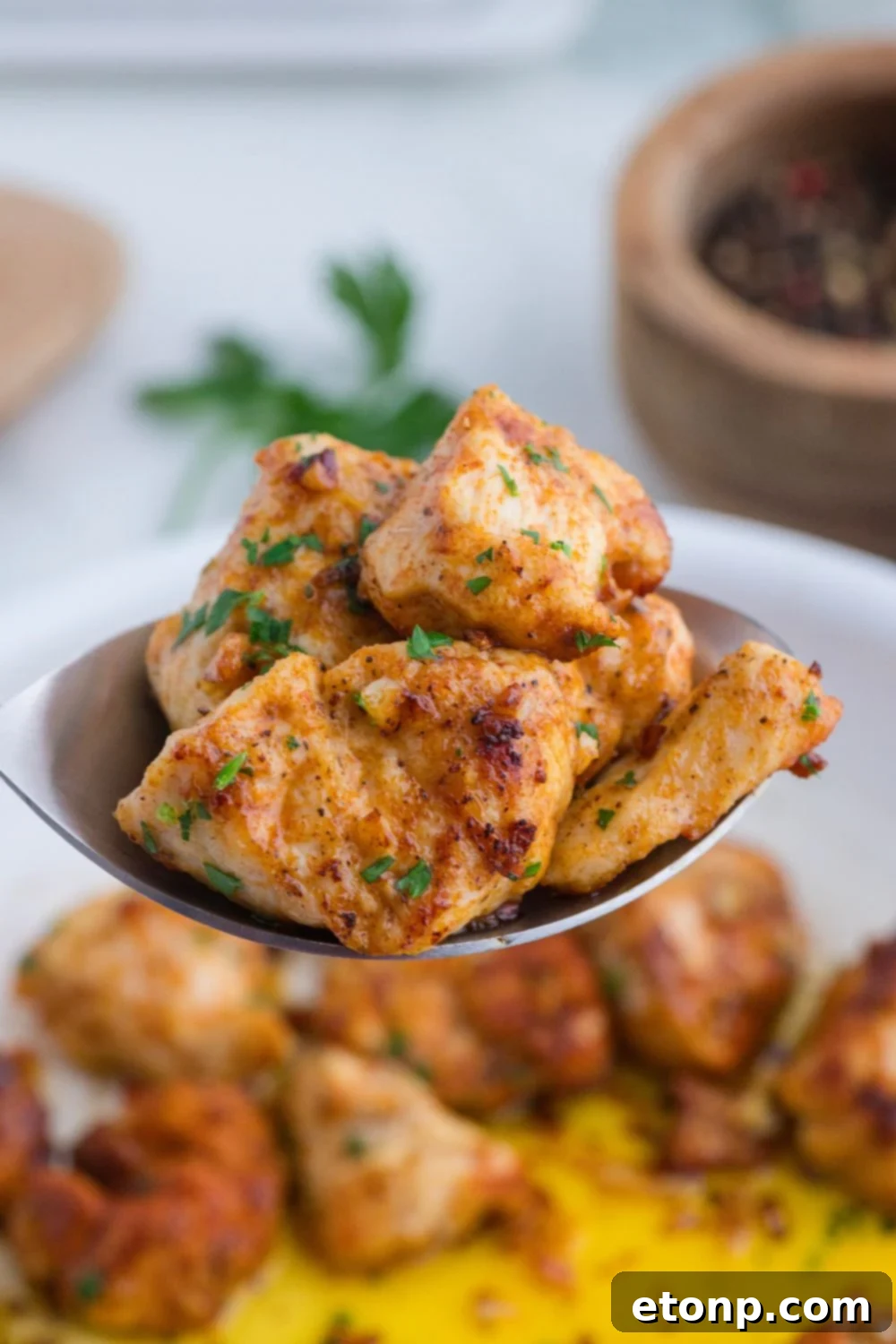 Buttery Garlic Chicken Bites 14 spoon of diced chicken above the skillet