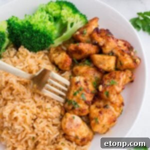 Buttery Garlic Chicken Bites 20 Garlic Butter Chicken Bites on plate with rice and broccoli on side of it