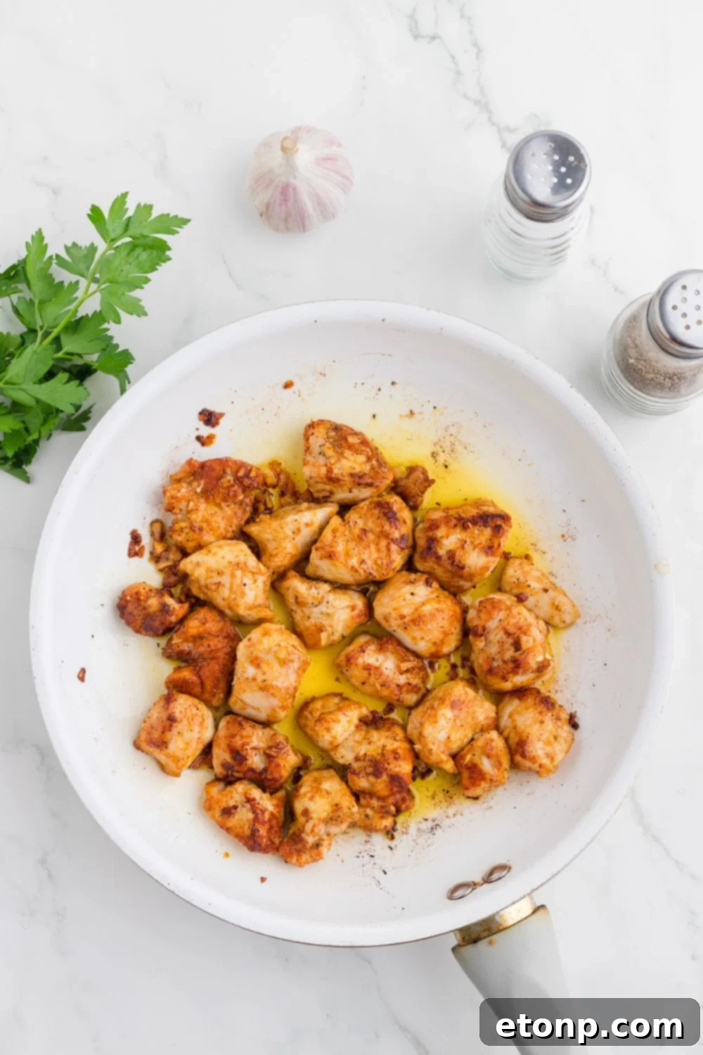 Buttery Garlic Chicken Bites 9 skillet with cooked Garlic Butter Chicken Bites in it