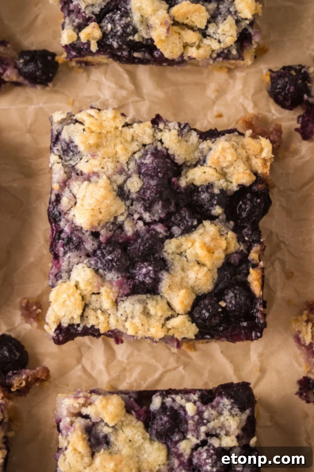 sliced Blueberry Crumb Bars on parchment paper