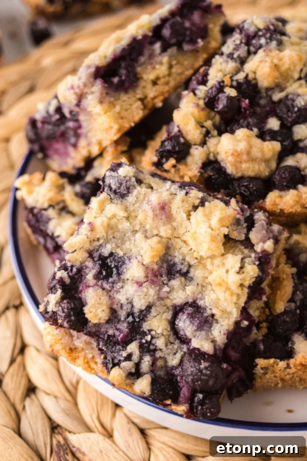 Blueberry Crumb Bars in a bowl that are sliced in squares 