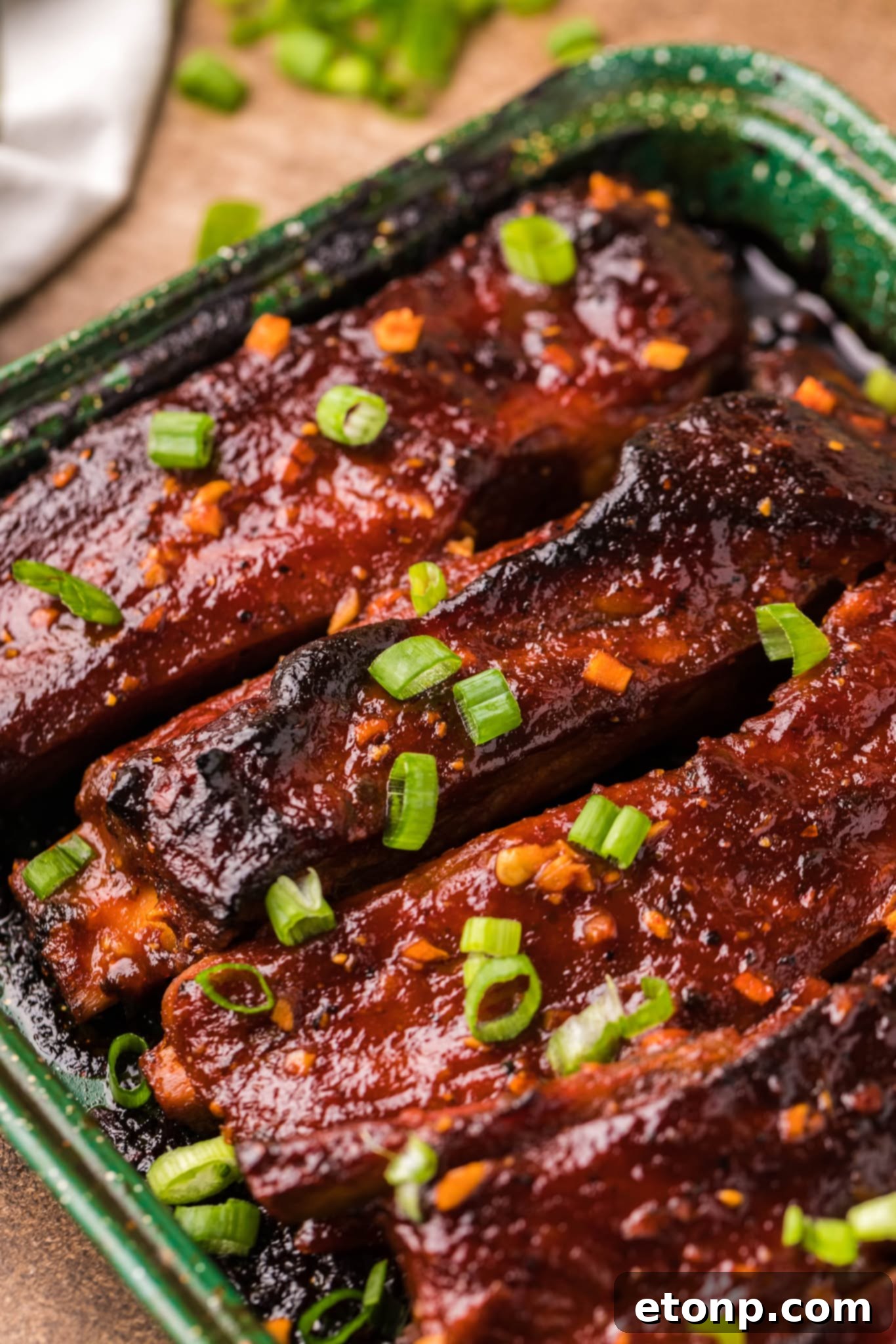 Spicy Sticky Pork Ribs, plated with garnish