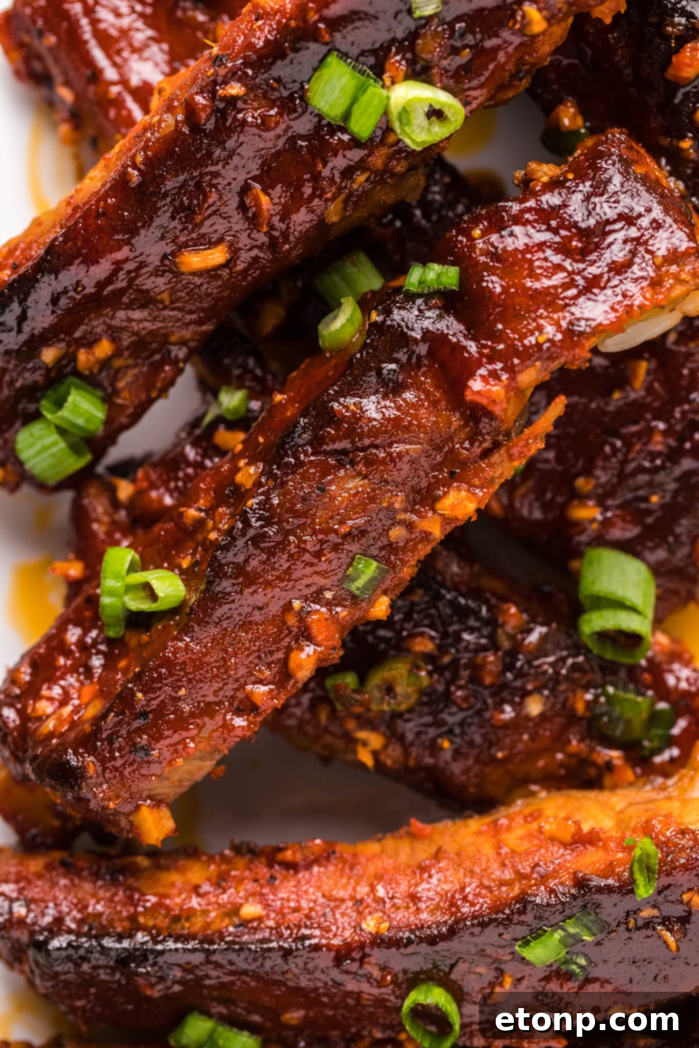 Plated Spicy Sticky Pork Ribs with side dishes