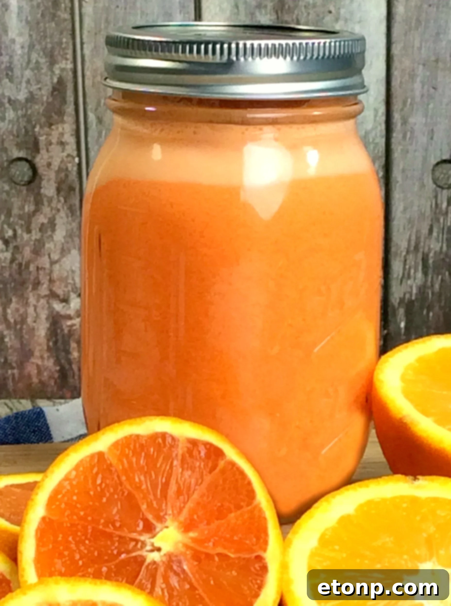 Delicious Homemade Orange Creamsicle Moonshine in a glass jar, perfect for summer entertaining.