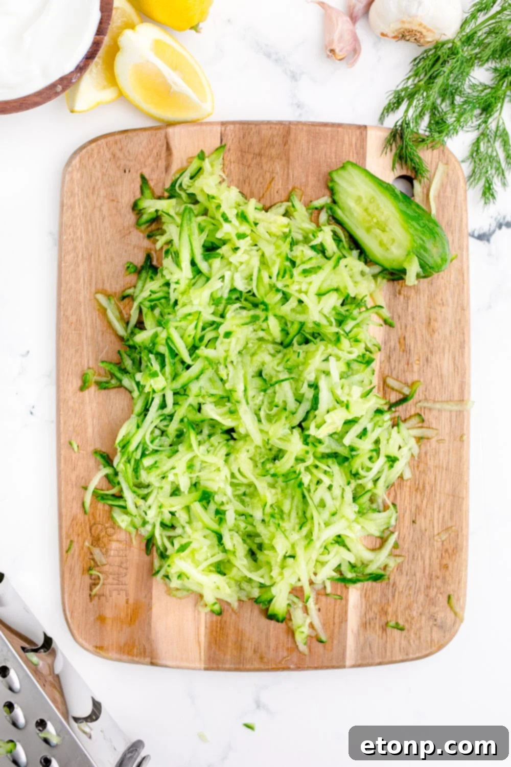 shredded cucumbers on a cutting board 