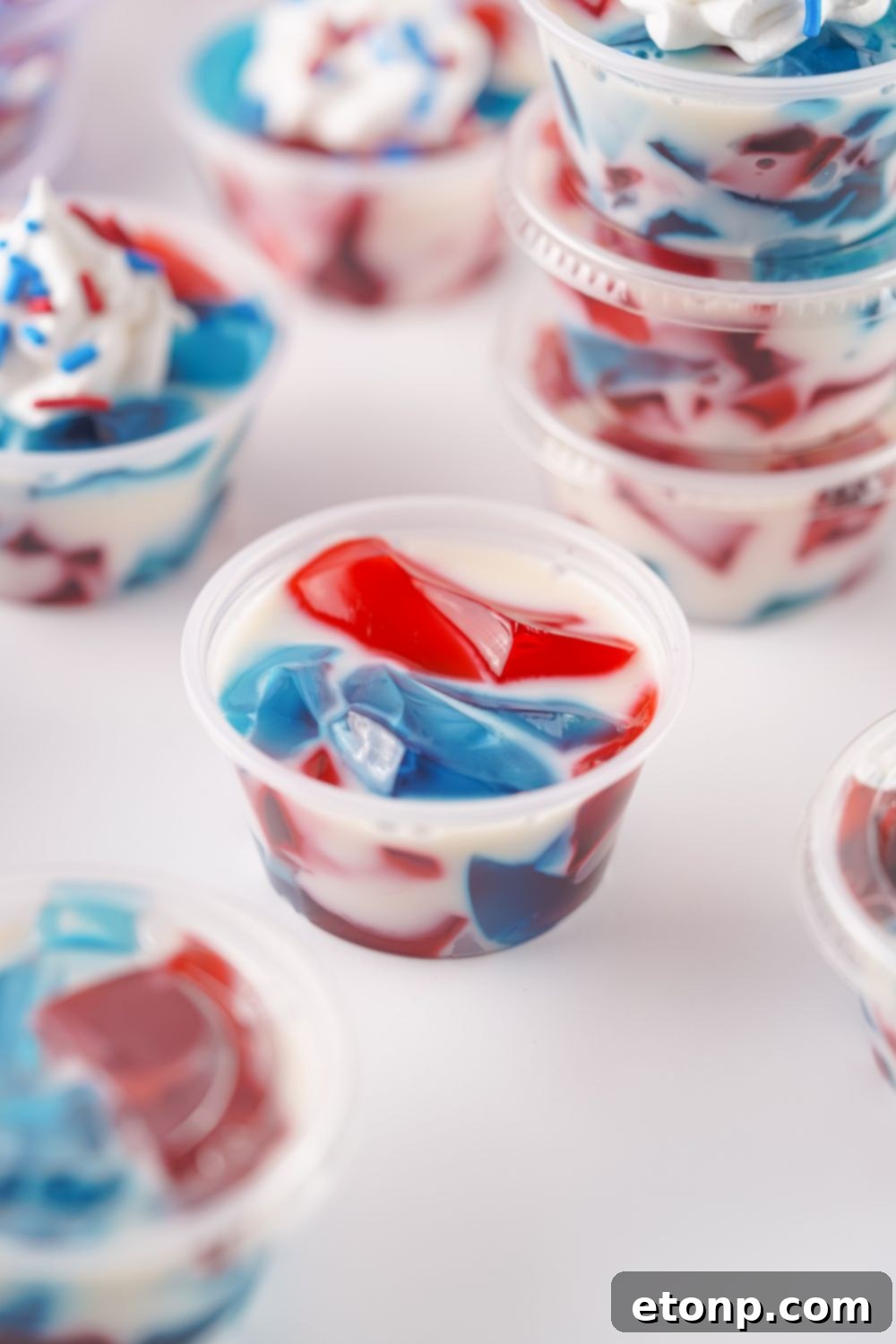 A close-up overhead shot of a single Red, White, and Blue Stained Glass Jello Shot in its container, showing the detailed layers.