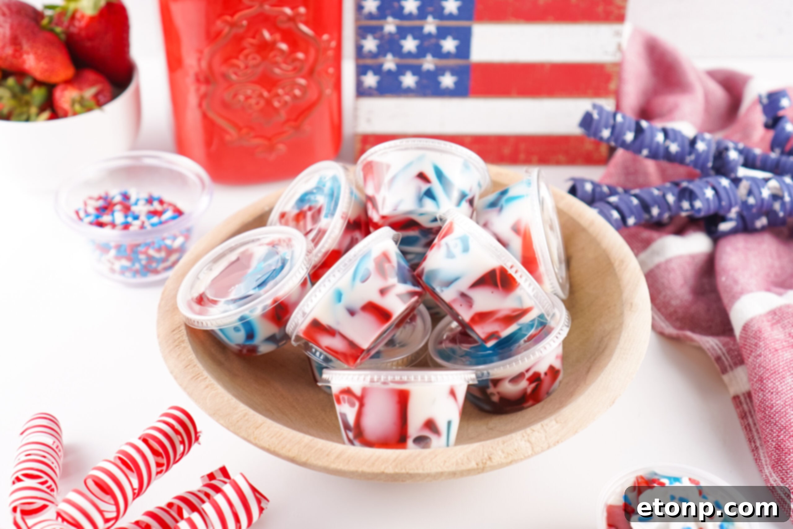 An overhead shot of Red, White, and Blue Stained Glass Jello Shots arranged in a decorative serving bowl, ready to be enjoyed.