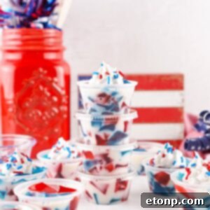 Red White and Blue Jello Shots in containers spread out on table with red white and blue decor in the background