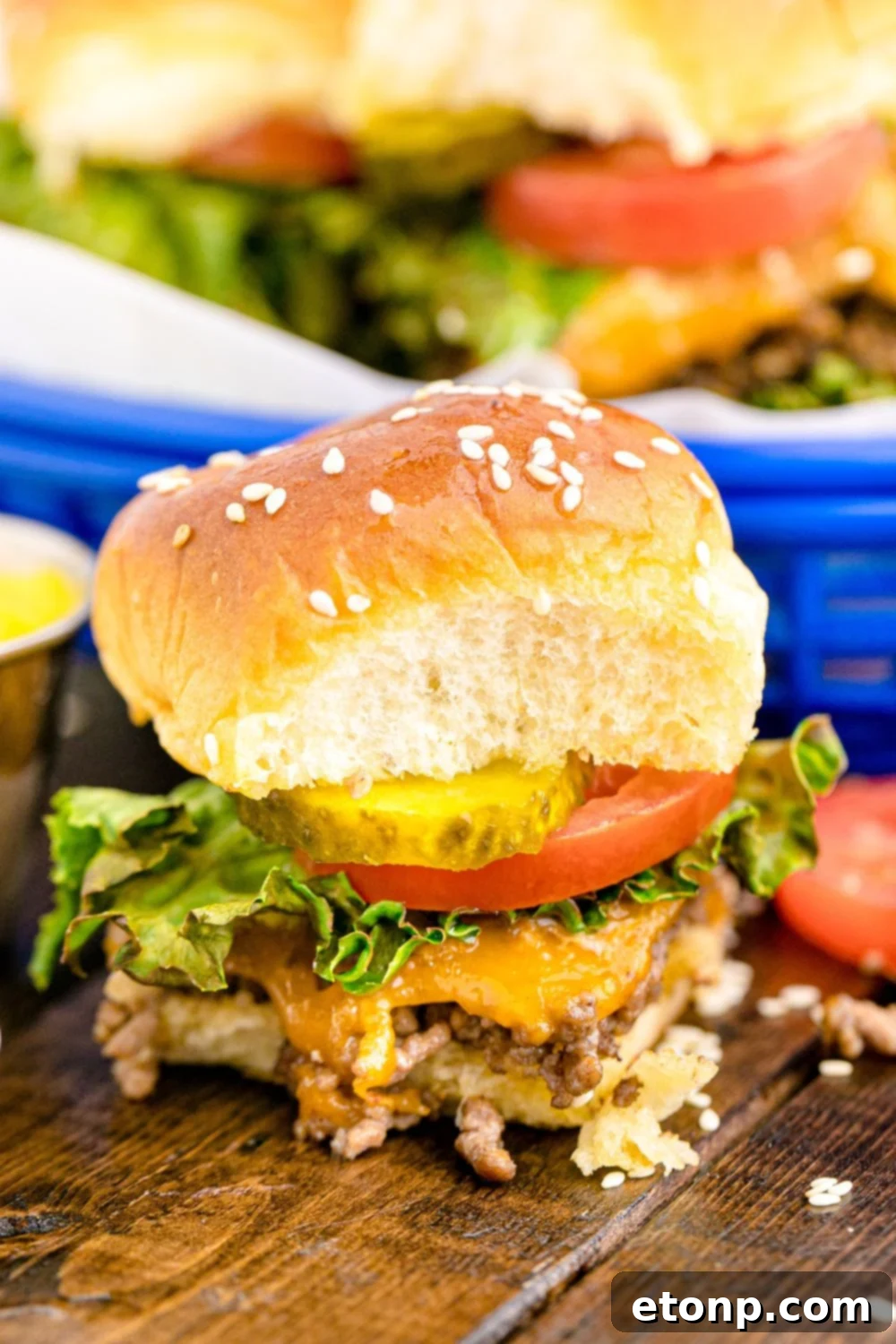 A beautiful arrangement of Classic Cheeseburger Sliders displayed on a rustic wooden table, showcasing their golden buns and savory filling, ready to be enjoyed.
