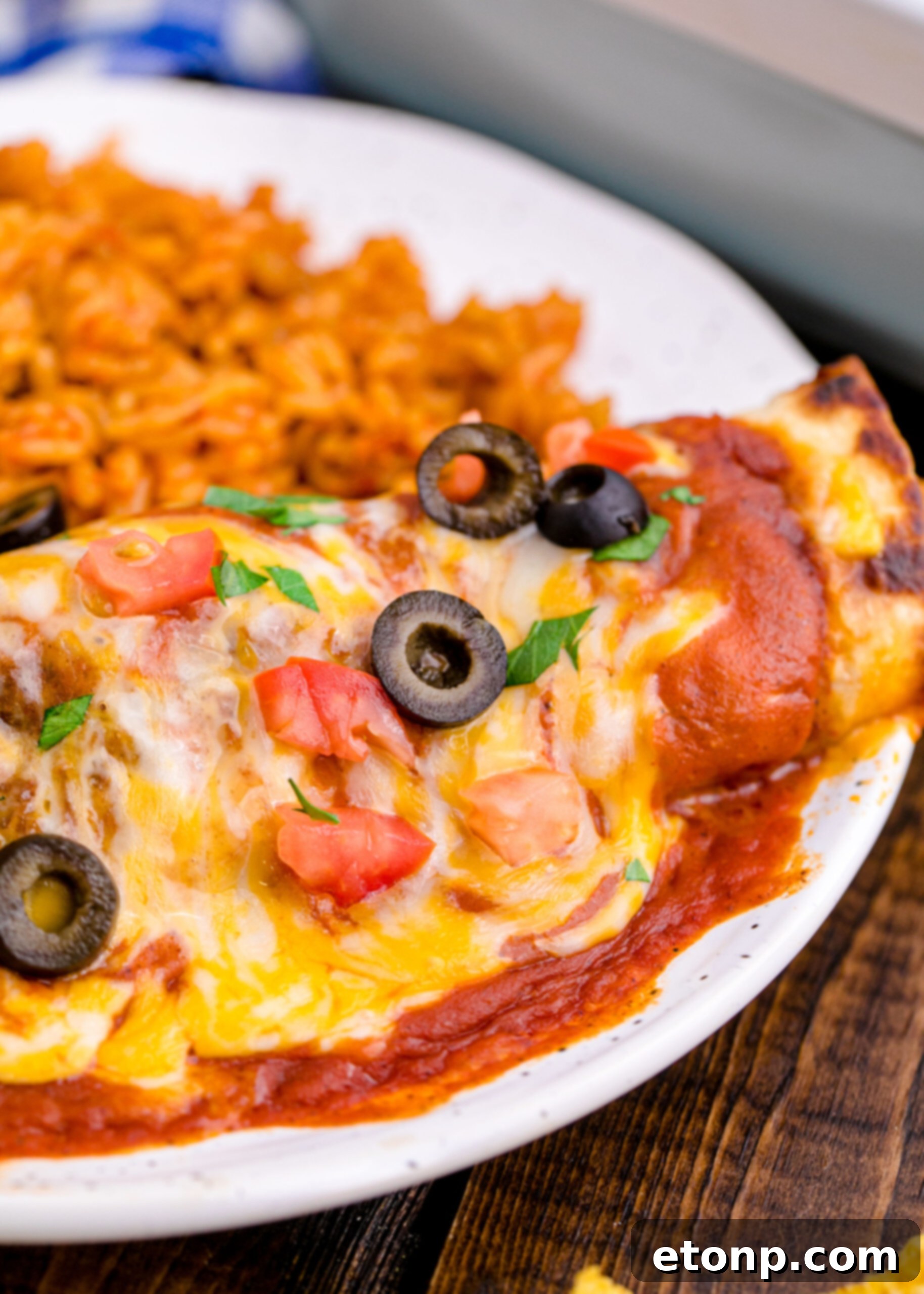 From Scratch Enchilada Perfection 16 Chicken Enchilada with Homemade Enchilada Sauce on it, glistening and ready to be enjoyed
