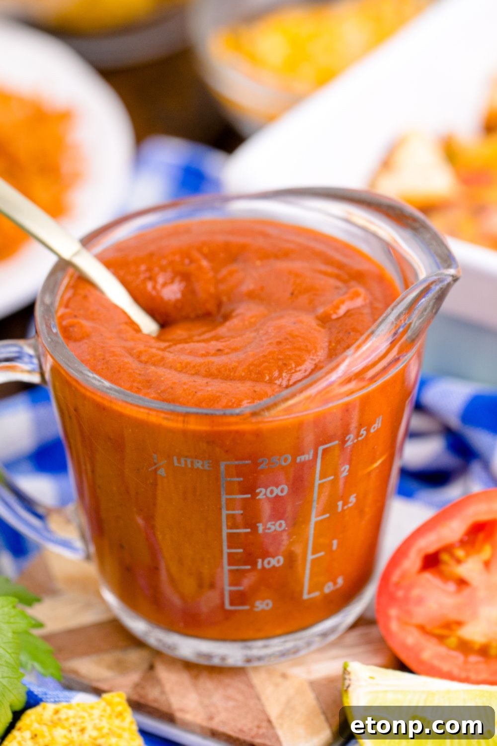 From Scratch Enchilada Perfection 4 Homemade Enchilada Sauce in a measuring cup with spoon inside container, ready to be served or stored