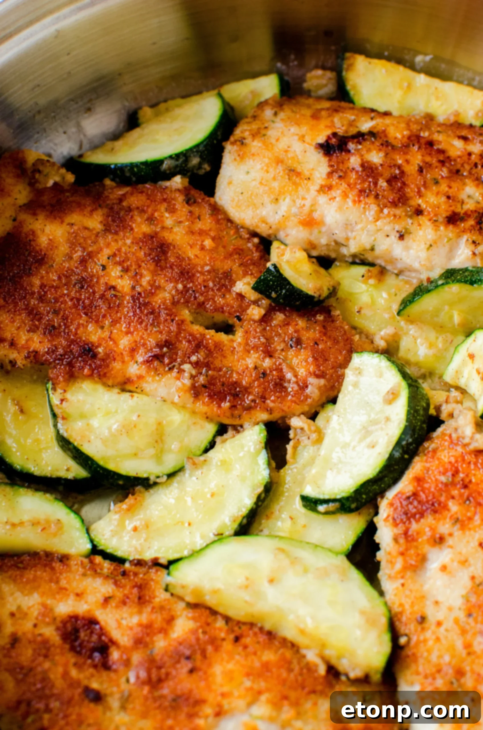 Crispy Parmesan Chicken and Garlicky Zucchini Skillet 4 Overhead view of a perfectly cooked pan-fried Parmesan chicken and zucchini dish