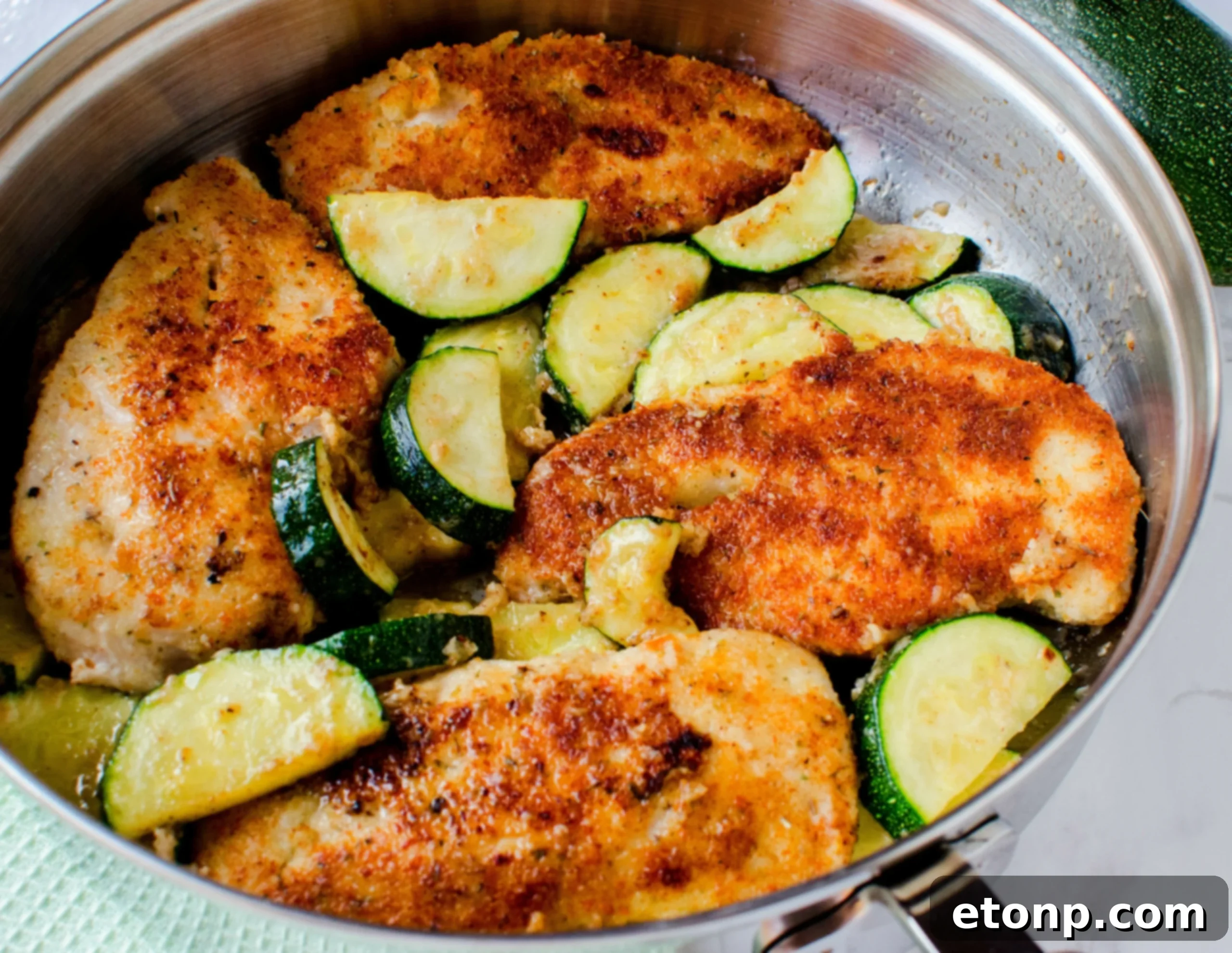 Crispy Parmesan Chicken and Garlicky Zucchini Skillet 5 Serving of crispy pan-fried chicken and tender zucchini on a plate