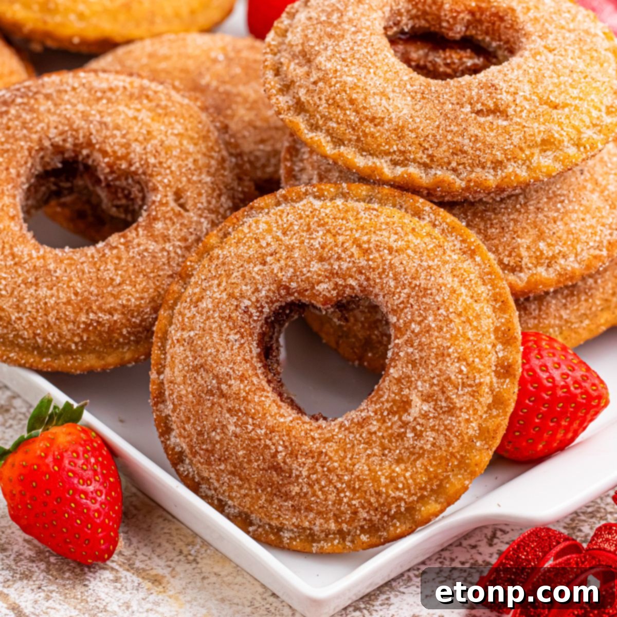 TikTok Fried Strawberry Uncrustables 3 Close-up of fried strawberry Uncrustables arranged on a plate with scattered fresh strawberries