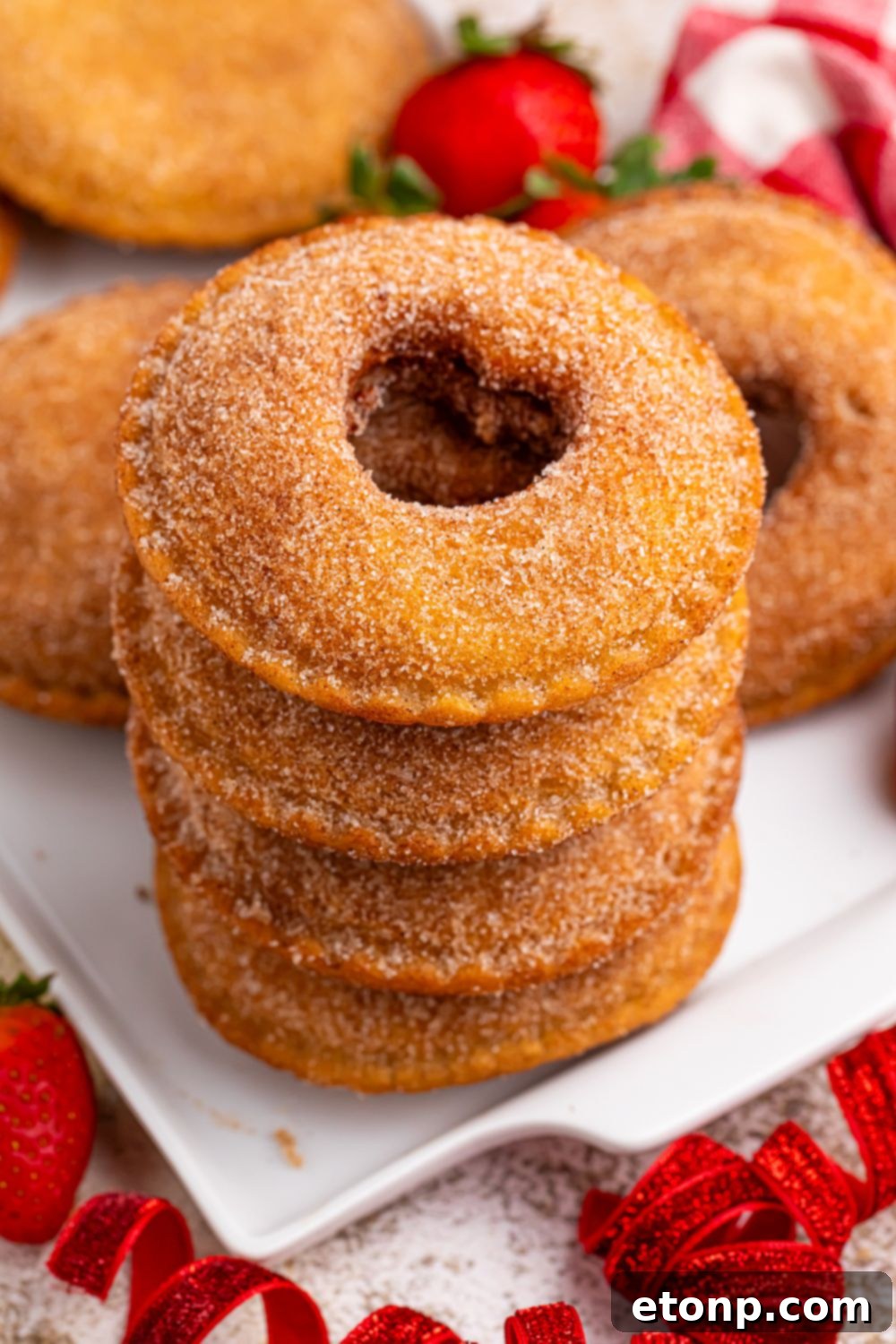 TikTok Fried Strawberry Uncrustables 4 Stack of freshly fried strawberry Uncrustables dusted with cinnamon sugar, arranged artfully on a plate