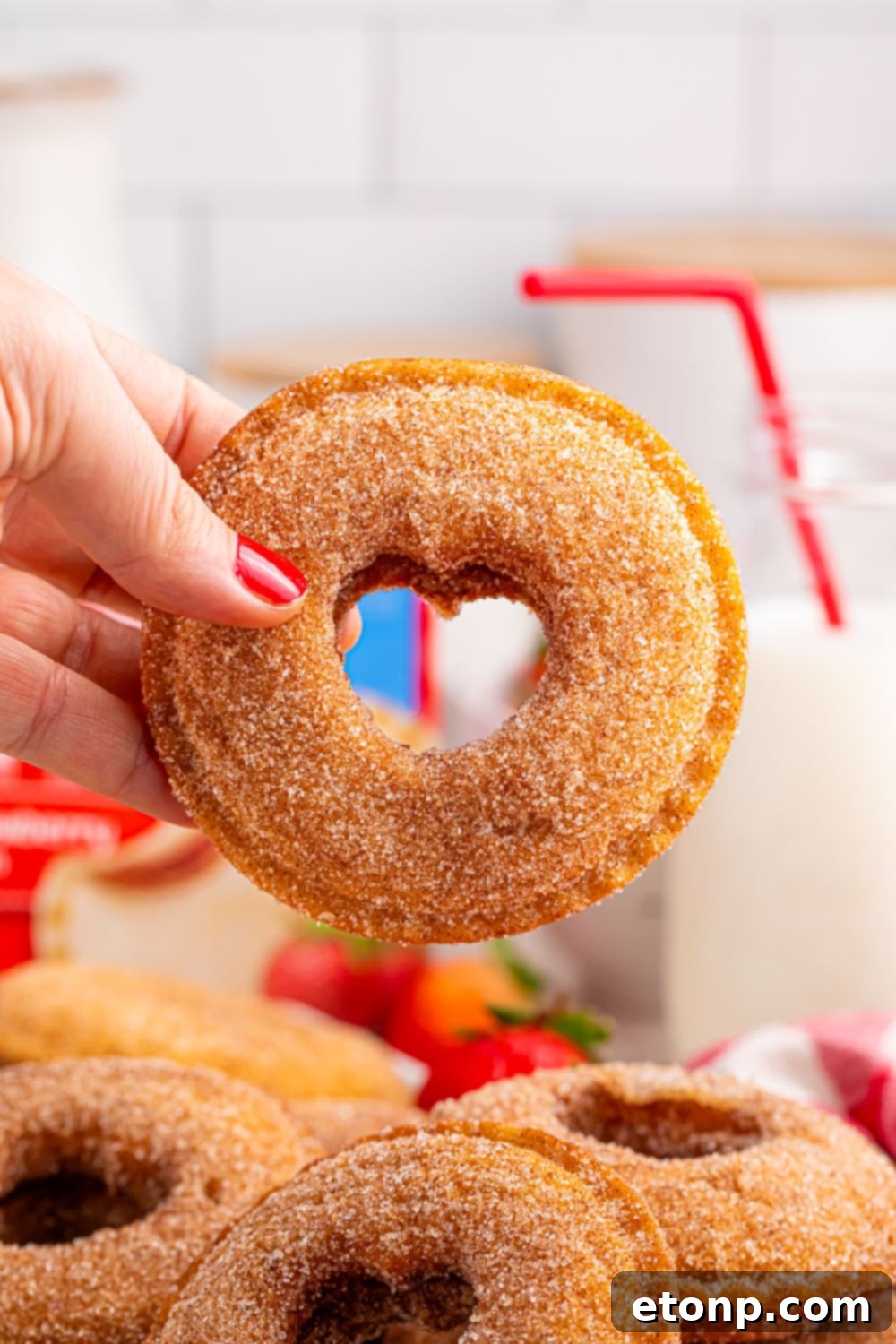 TikTok Fried Strawberry Uncrustables 5 Hand holding a fried strawberry Uncrustable with a heart cutout, showing the warm, fruity interior