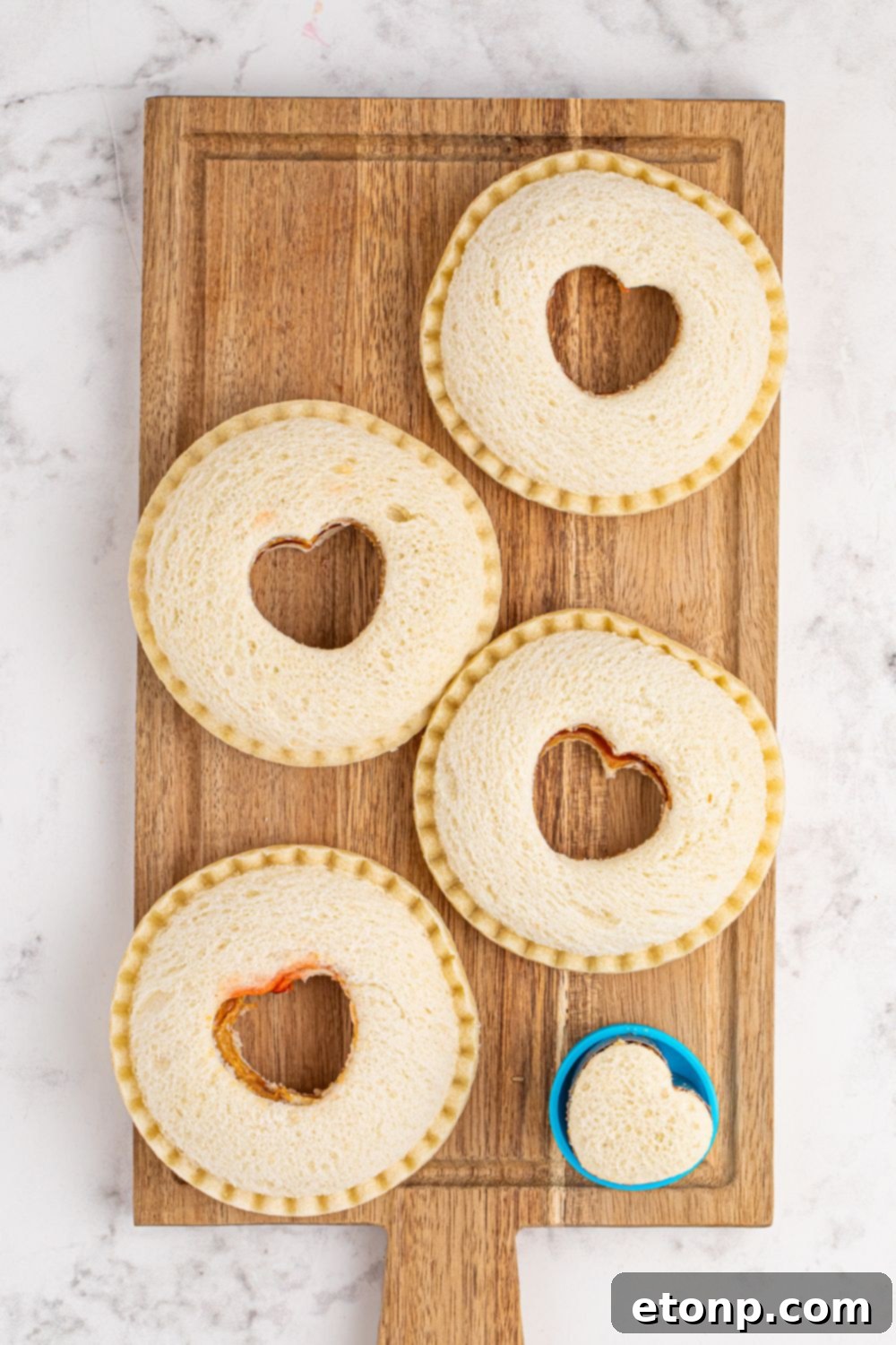 TikTok Fried Strawberry Uncrustables 10 Thawed Uncrustables with heart shapes already cut out in their centers, ready for frying