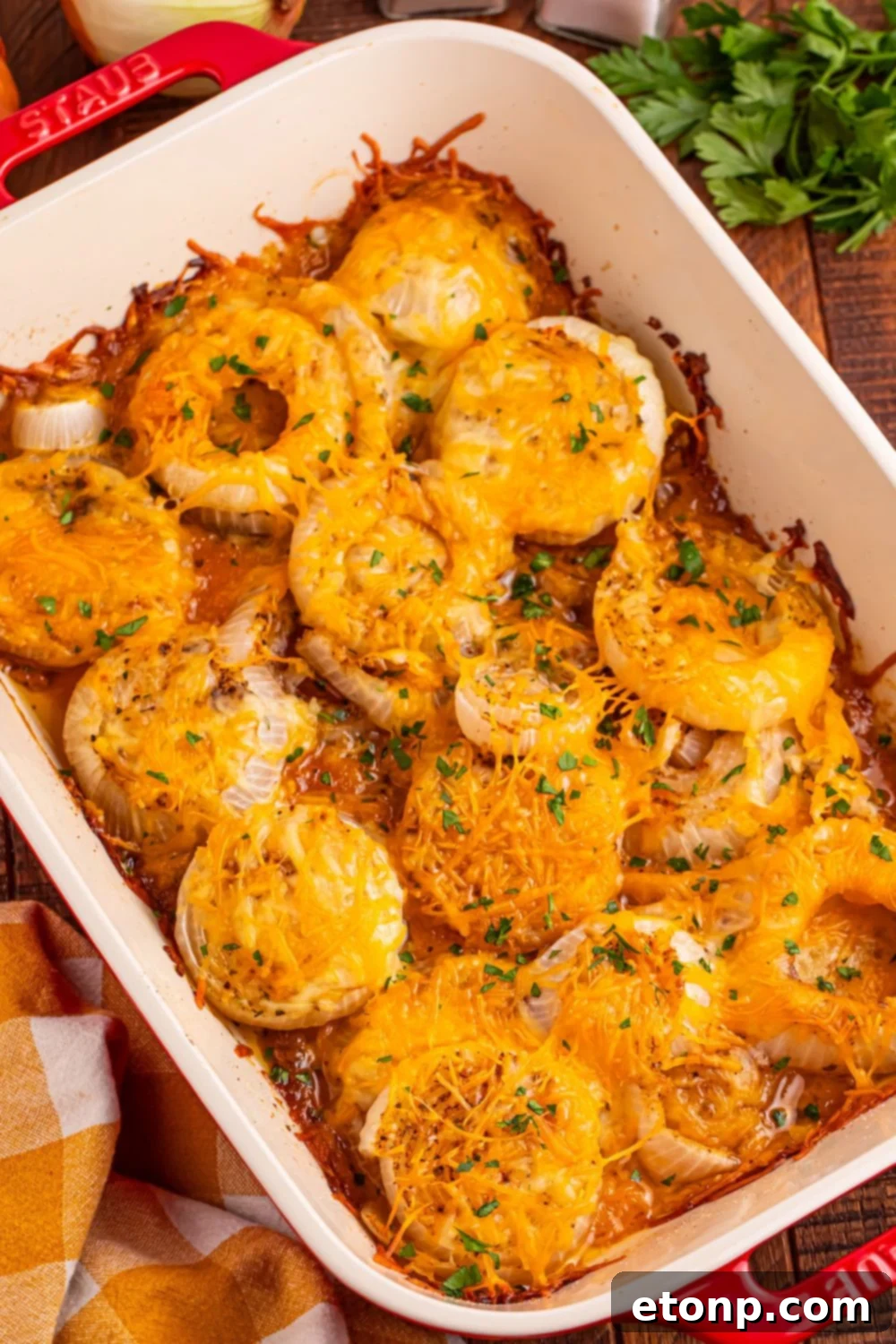 Cheesy Tennessee Onion Bake 17 Cheesy Tennessee Onions in a casserole dish, topped with fresh parsley for garnish.