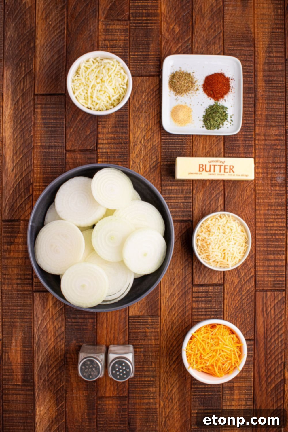 Cheesy Tennessee Onion Bake 7 Ingredients for Cheesy Tennessee Onions, neatly arranged in small bowls on a wooden table.
