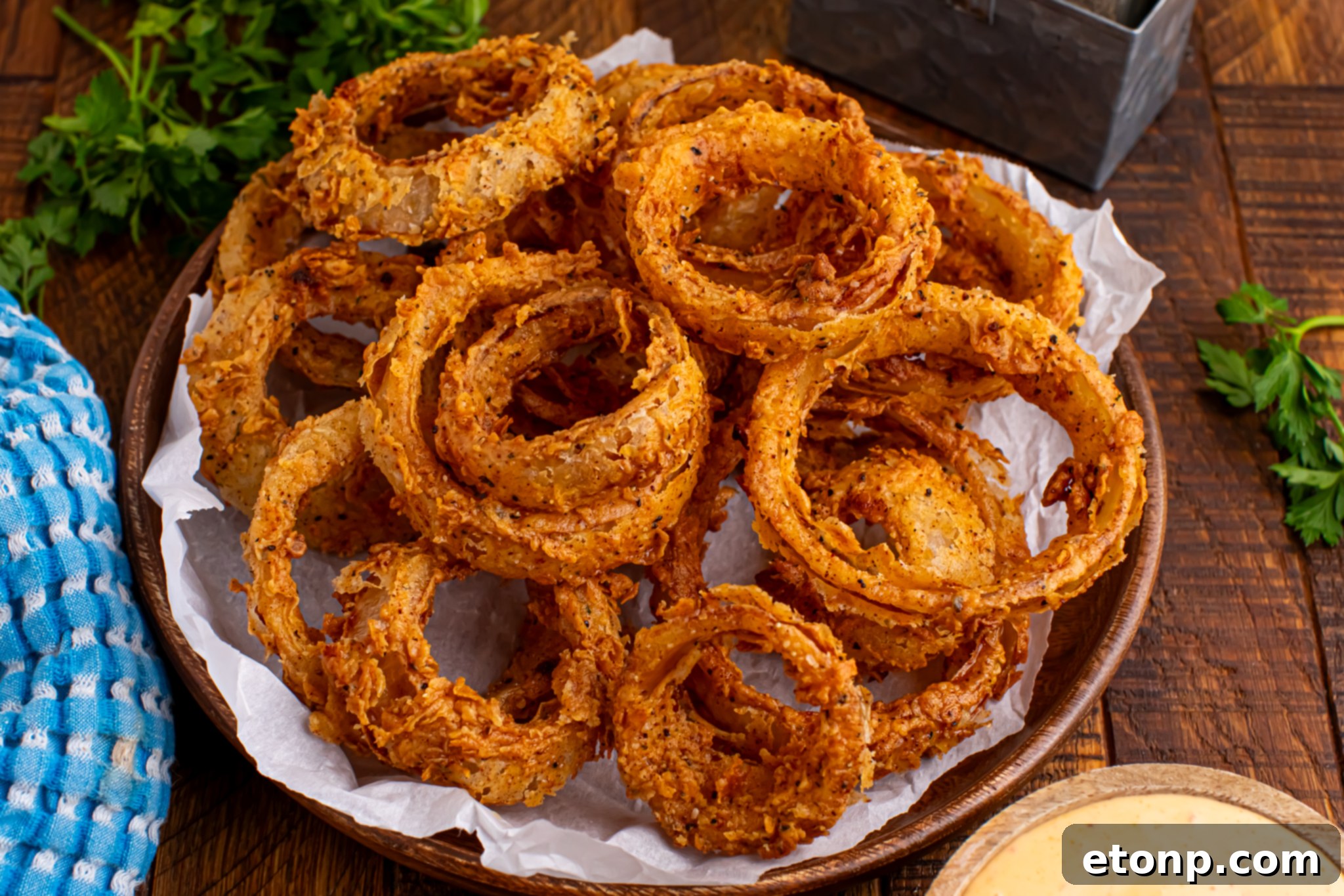 Golden Crispy Homemade Onion Rings 23 deep friend onion rings on a dark wood table