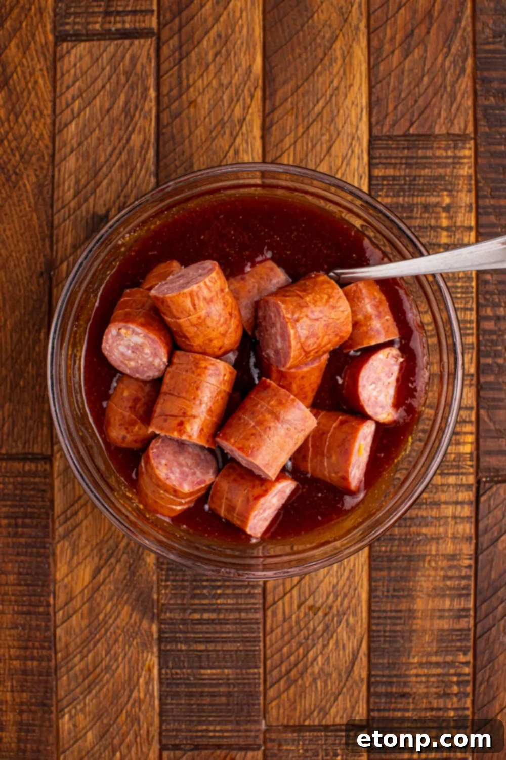 smoked sausage in a bowl with sauce 