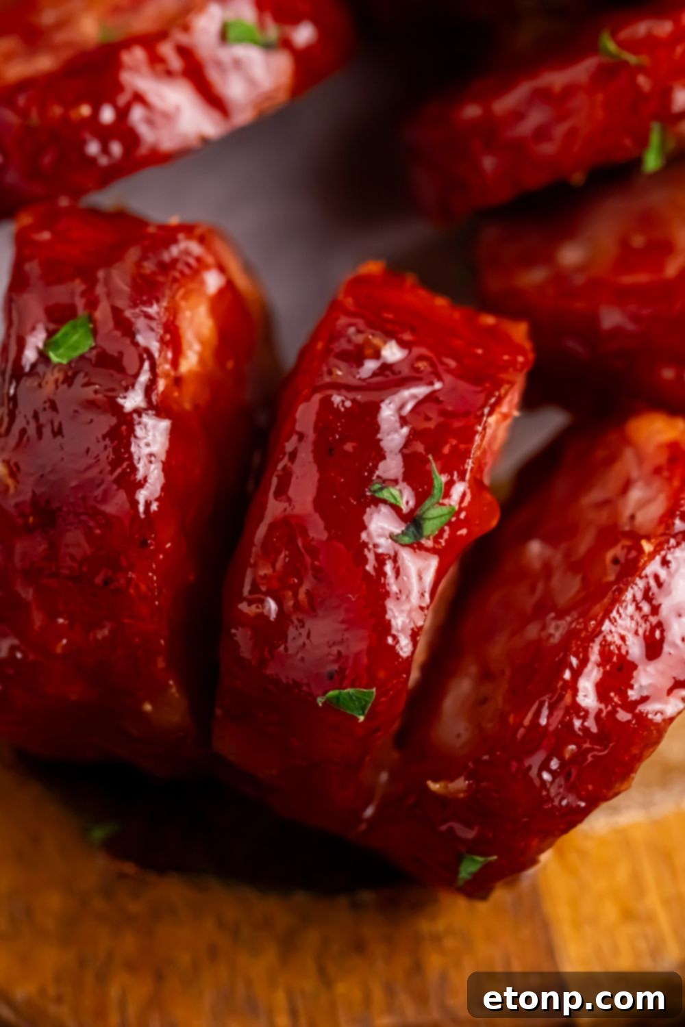 close up of BBQ Hasselback Smoked Sausages on table to see the cuts on the meat 