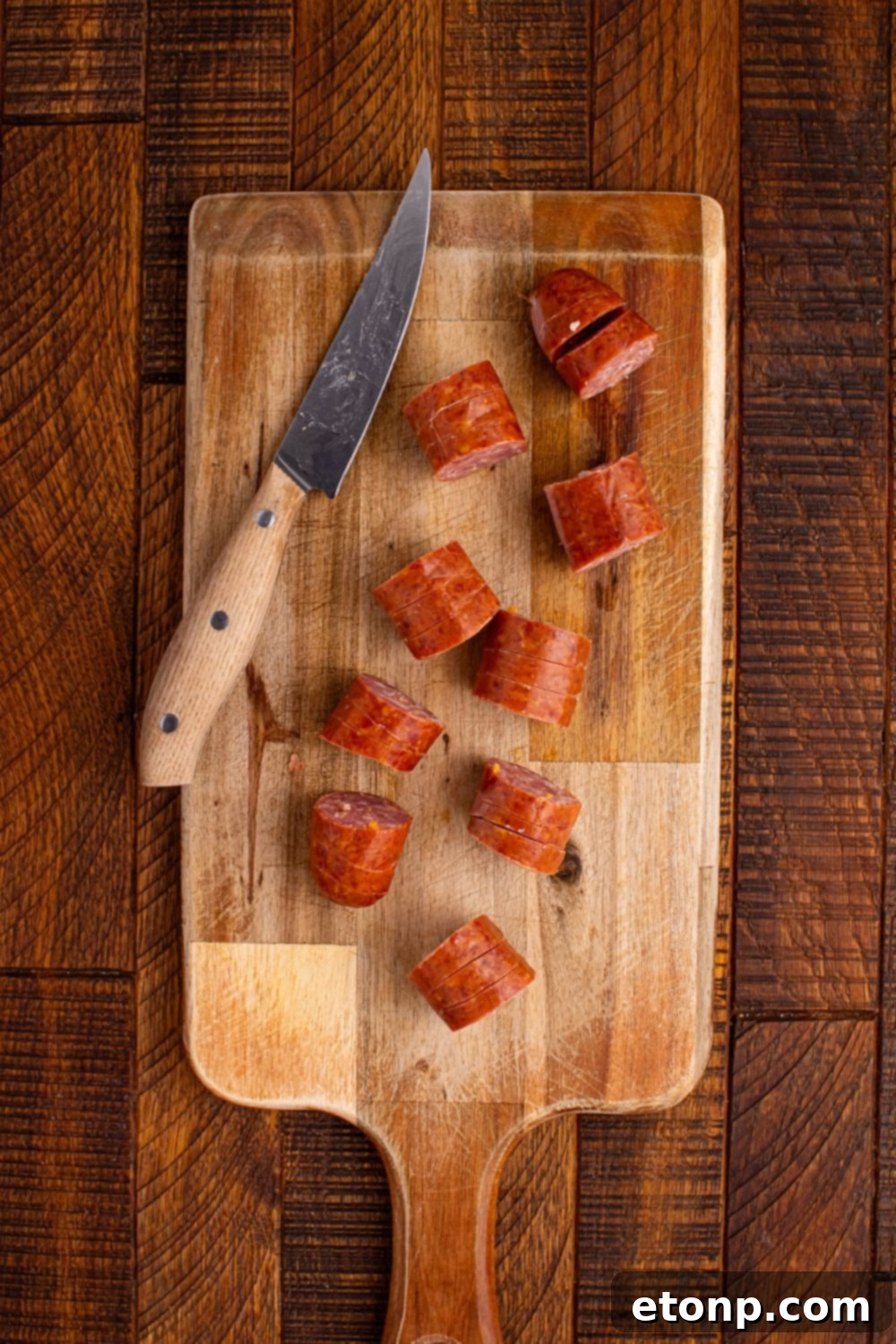 sliced BBQ Hasselback Smoked Sausages on a cutting board 
