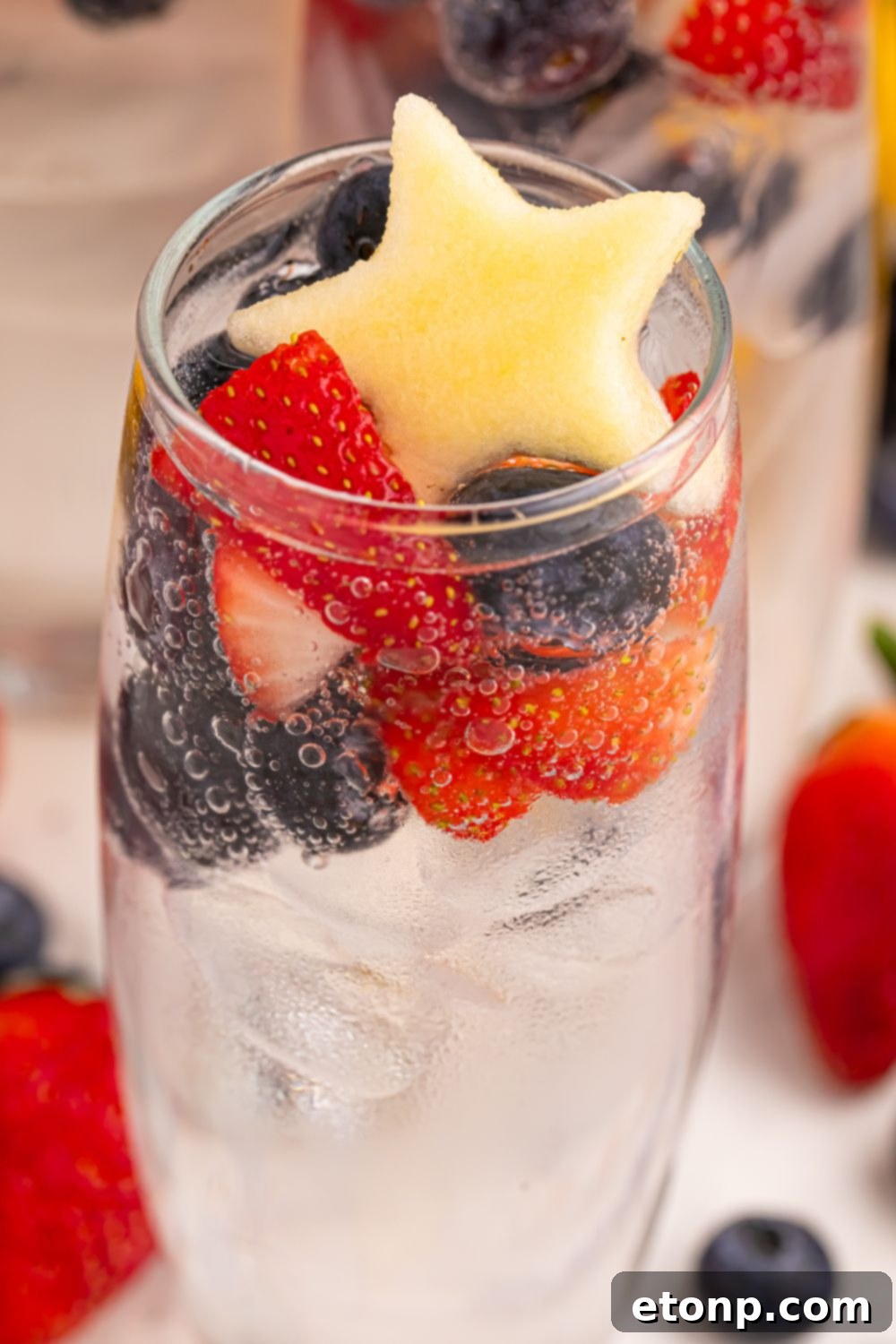 Liberty Lemon Sparkle 20 glass with Patriotic Sparkling Lemonade and fruit on top of glass
