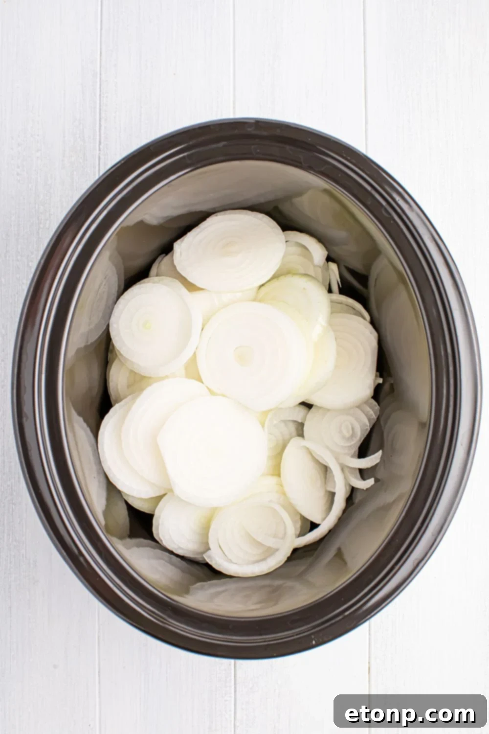 sliced onions in slow cooker for making Crockpot caramelized onions 