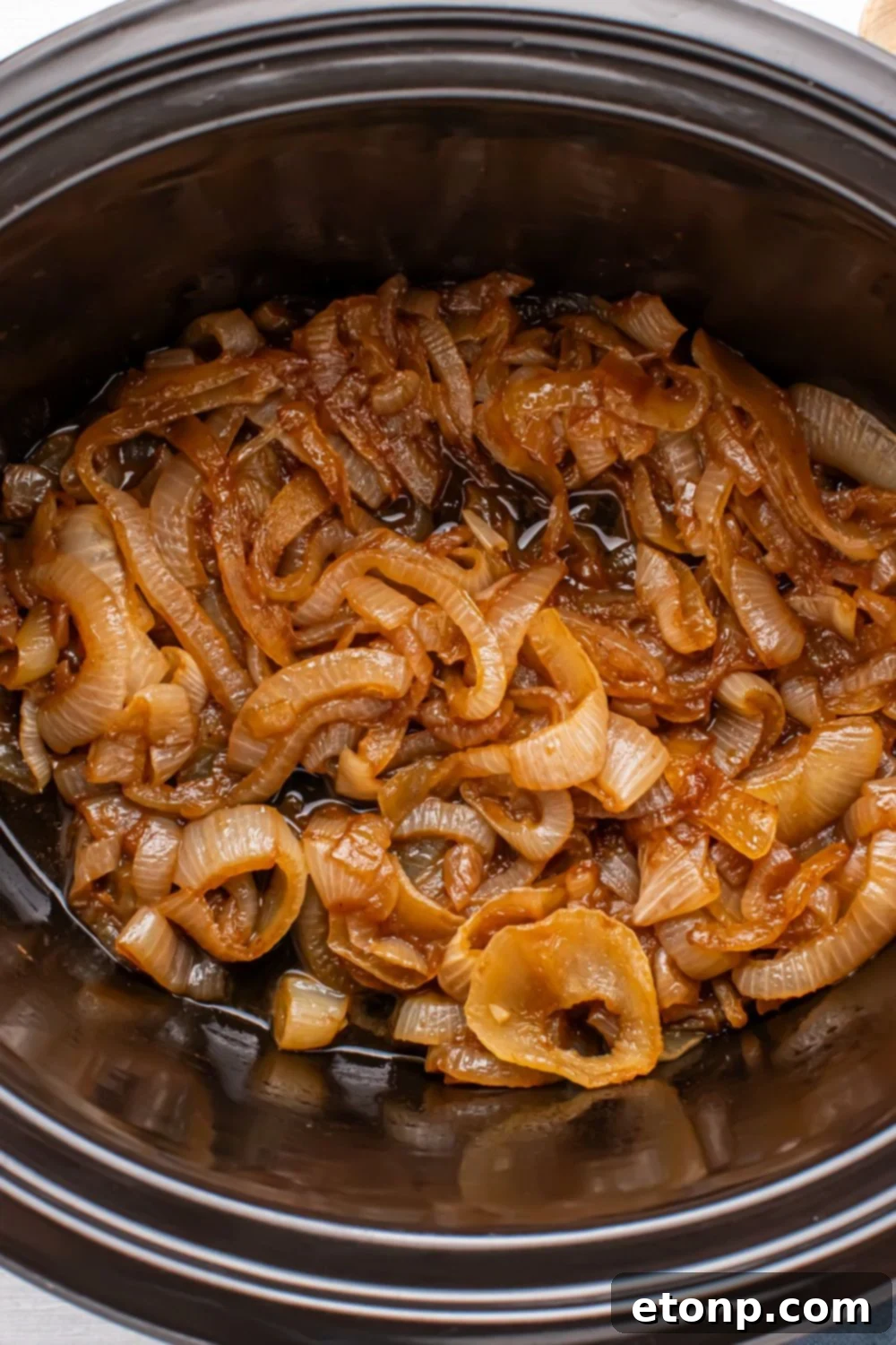 crockpot with caramelized onions in it sitting on a table