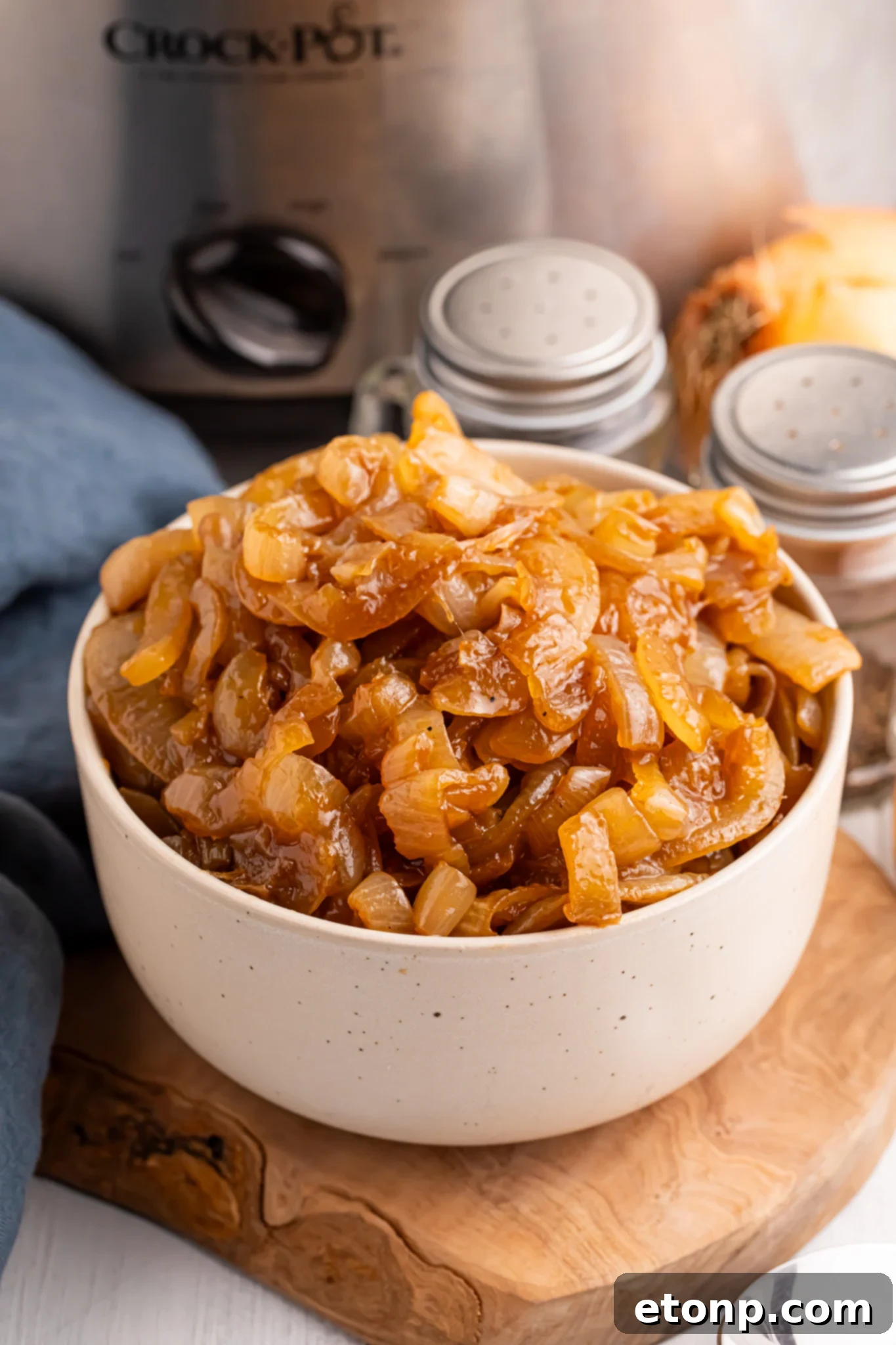 close up of a white bowl filled with the CrockPot Caramelized Onions 